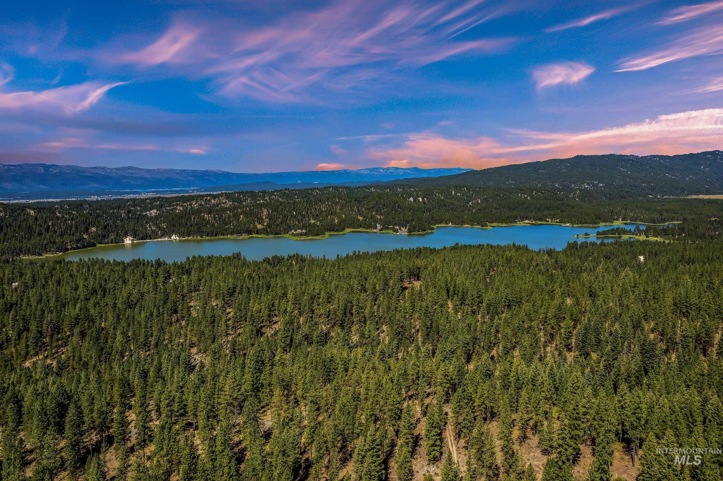 Water view with a mountain backdrop and a forest
