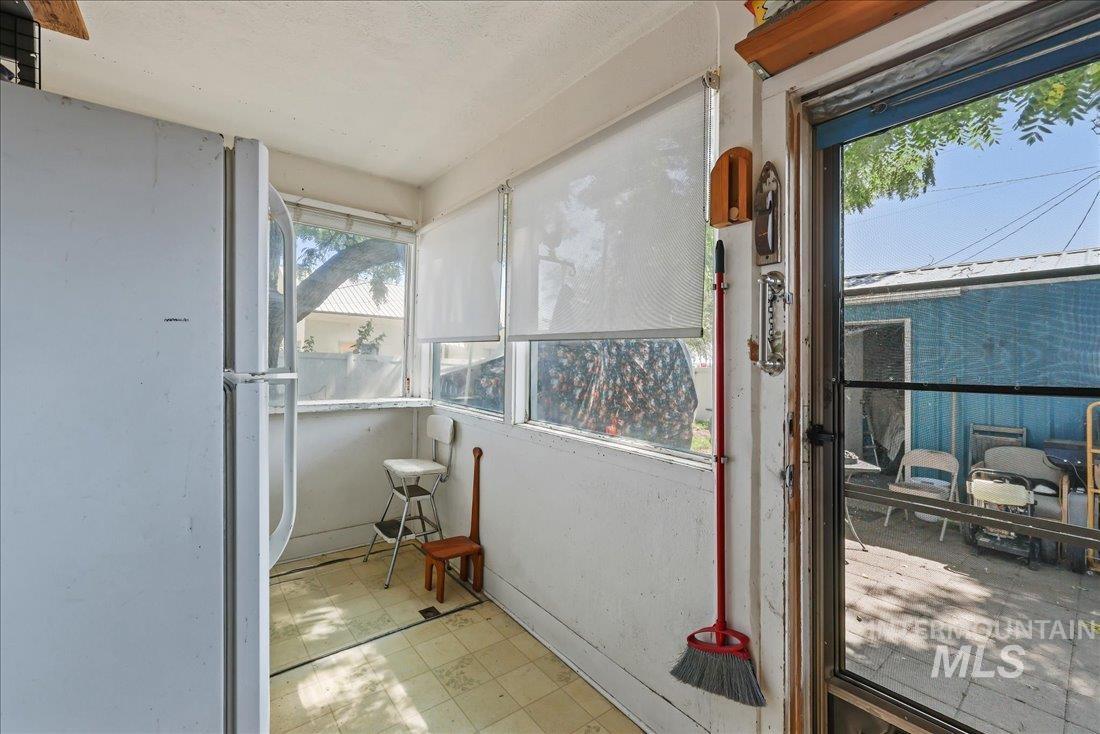 Doorway featuring tile patterned floors and healthy amount of natural light