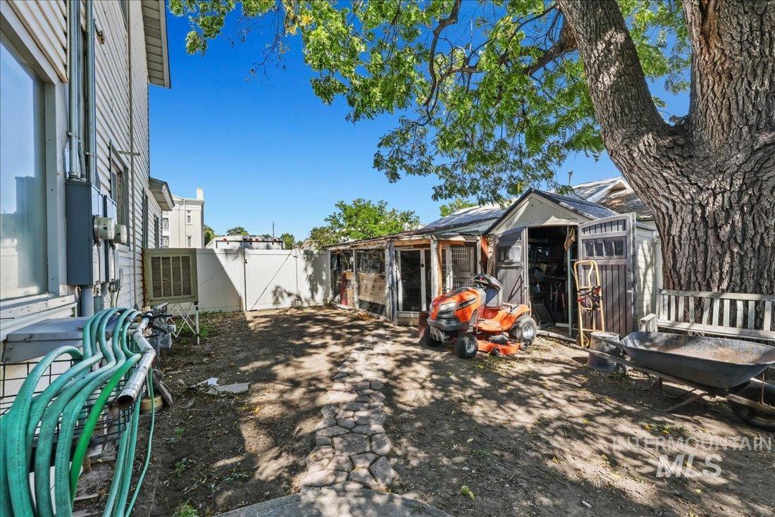 View of yard with a gate, an outbuilding, and exterior structure