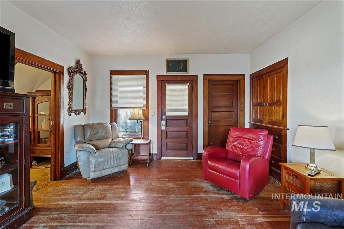 Living room with hardwood / wood-style flooring and baseboards