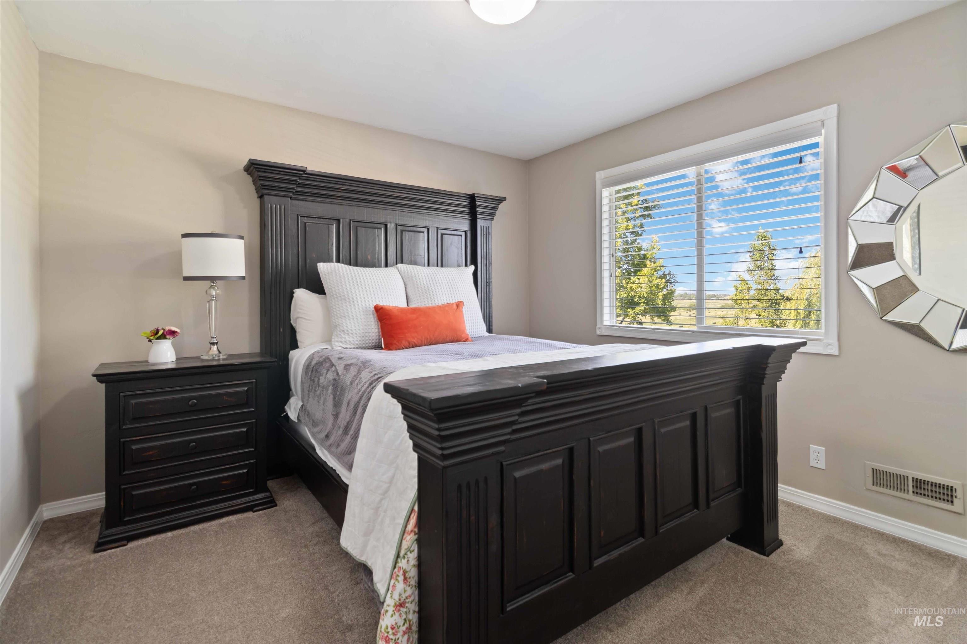 Bedroom featuring baseboards and light colored carpet