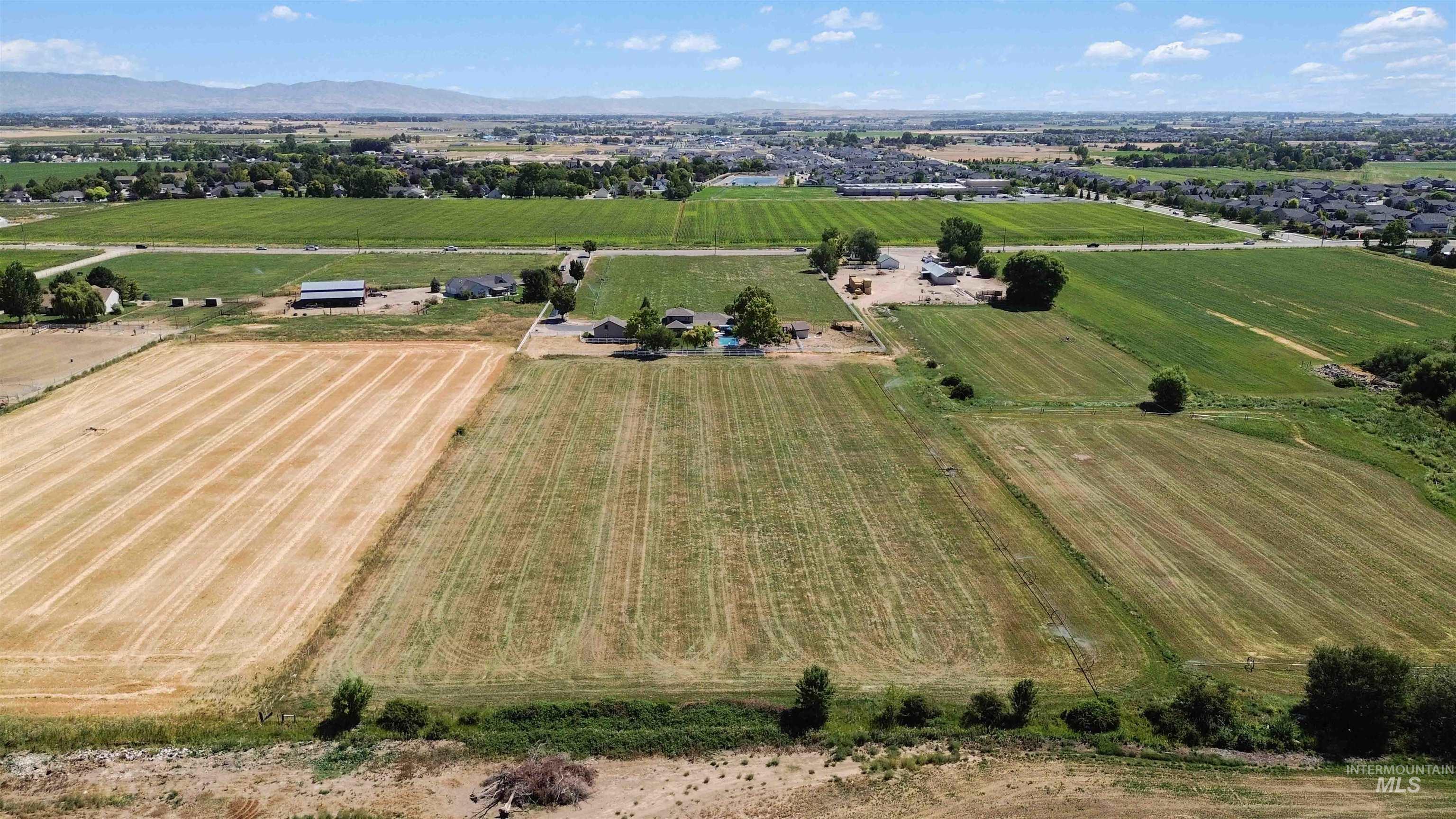 View of rural area with rows of crops and mountains