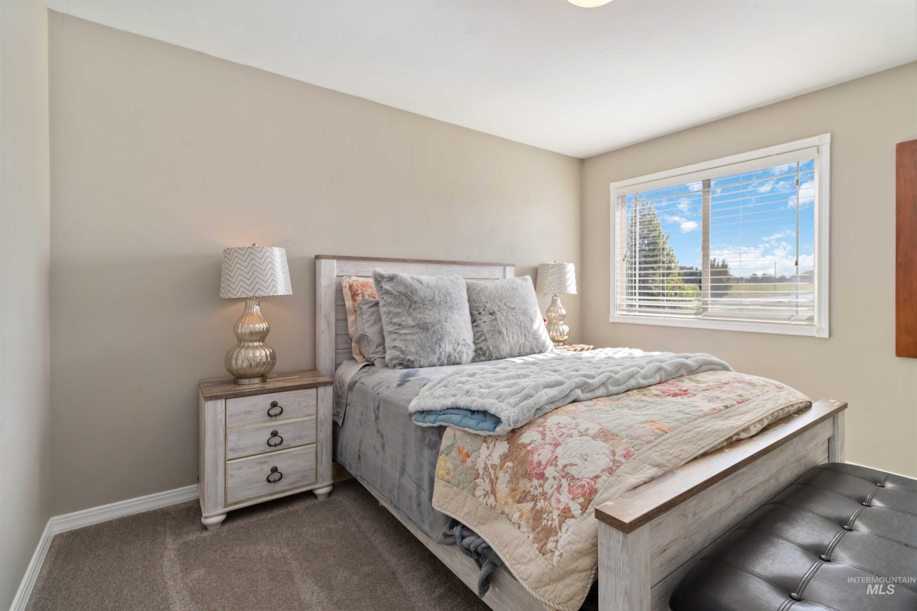 Bedroom with baseboards and carpet floors