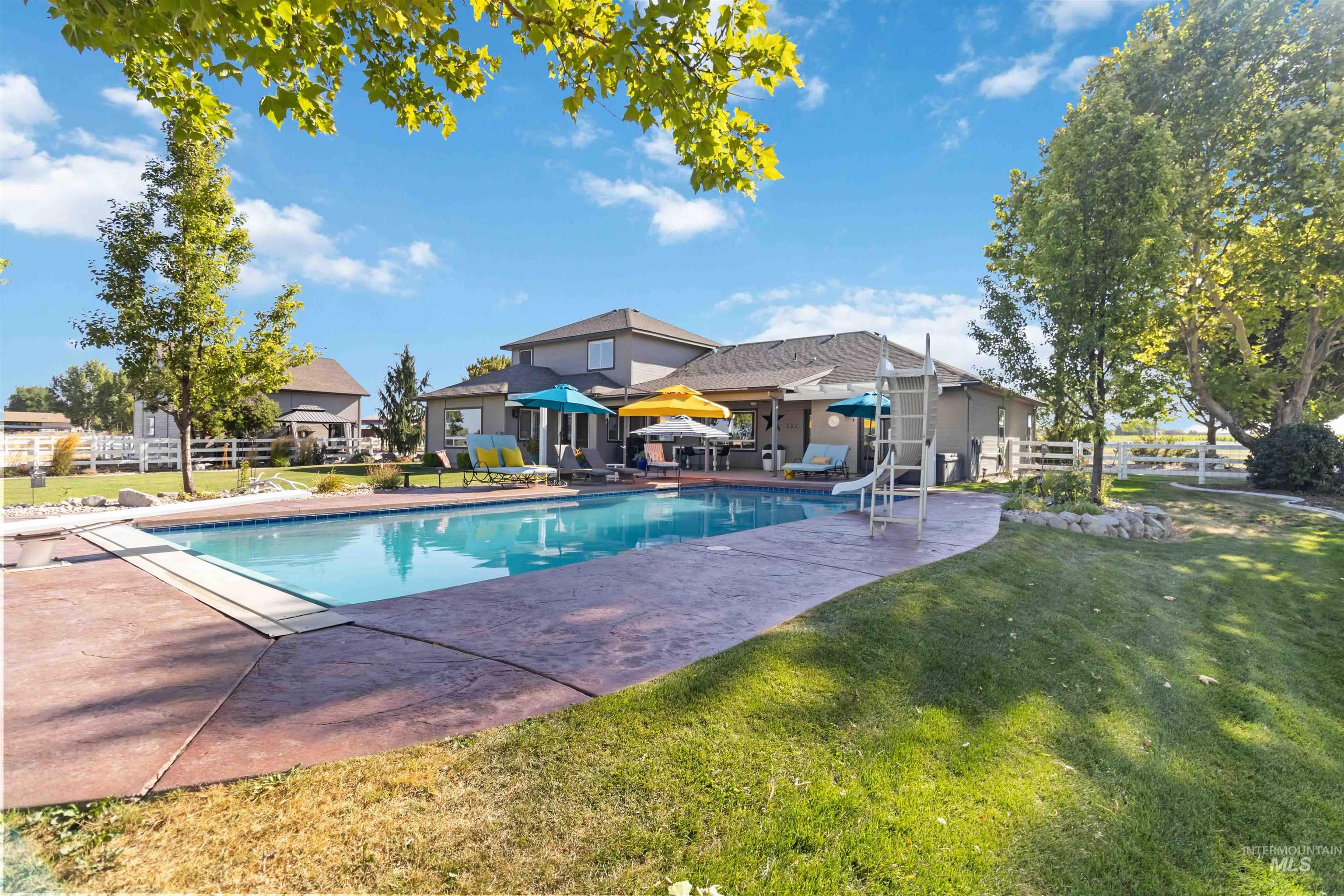 Swimming pool with a patio and a diving board