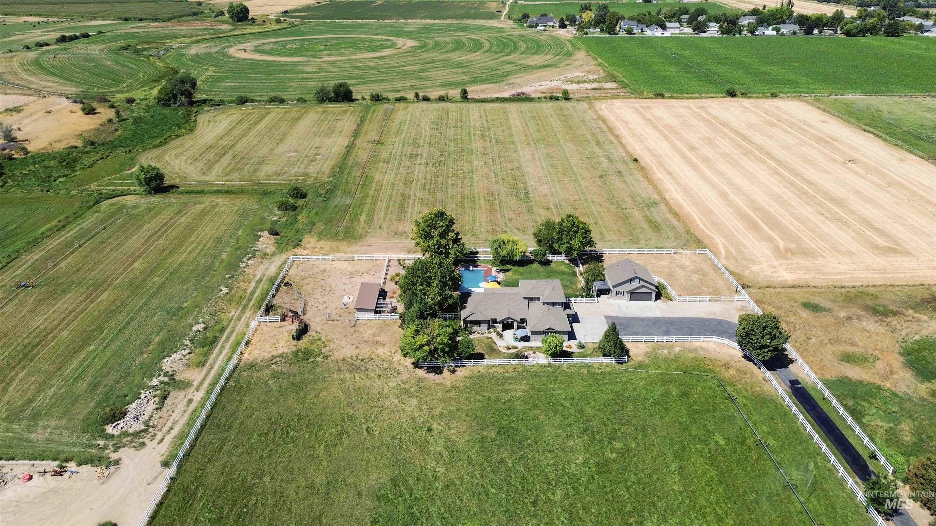 Aerial view of property and surrounding area featuring rural landscape
