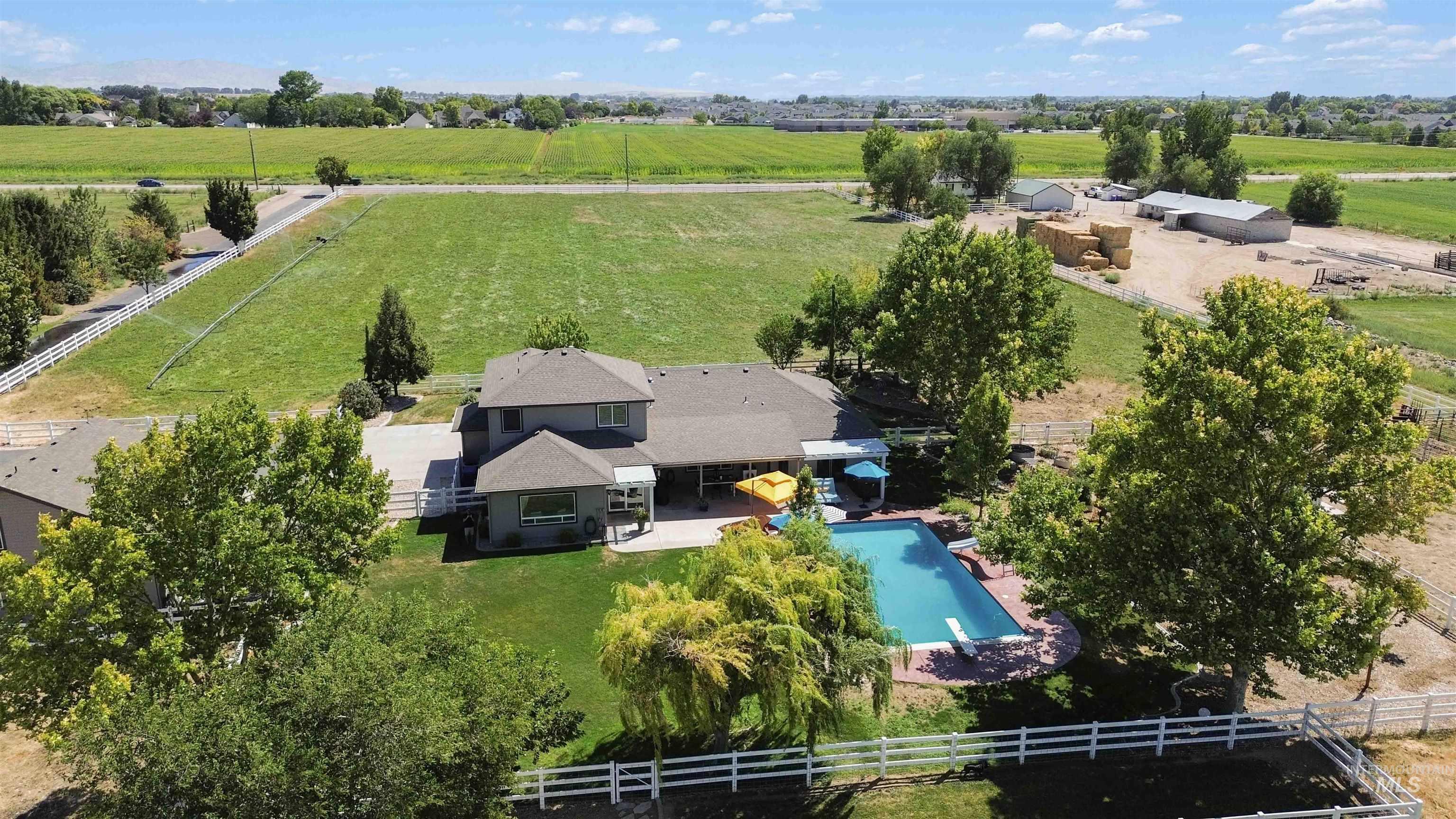 Overview of rural landscape featuring a pool and a pastoral area