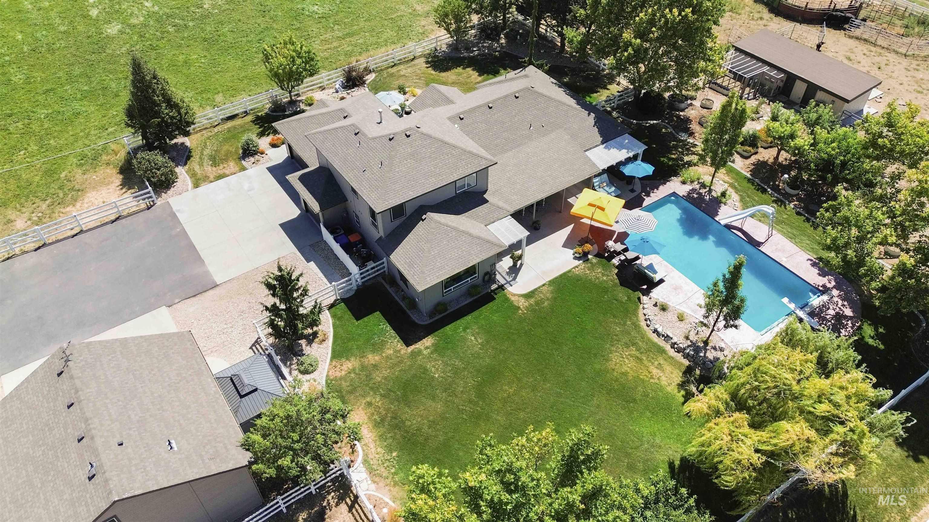 Aerial view of property and surrounding area featuring a pool area