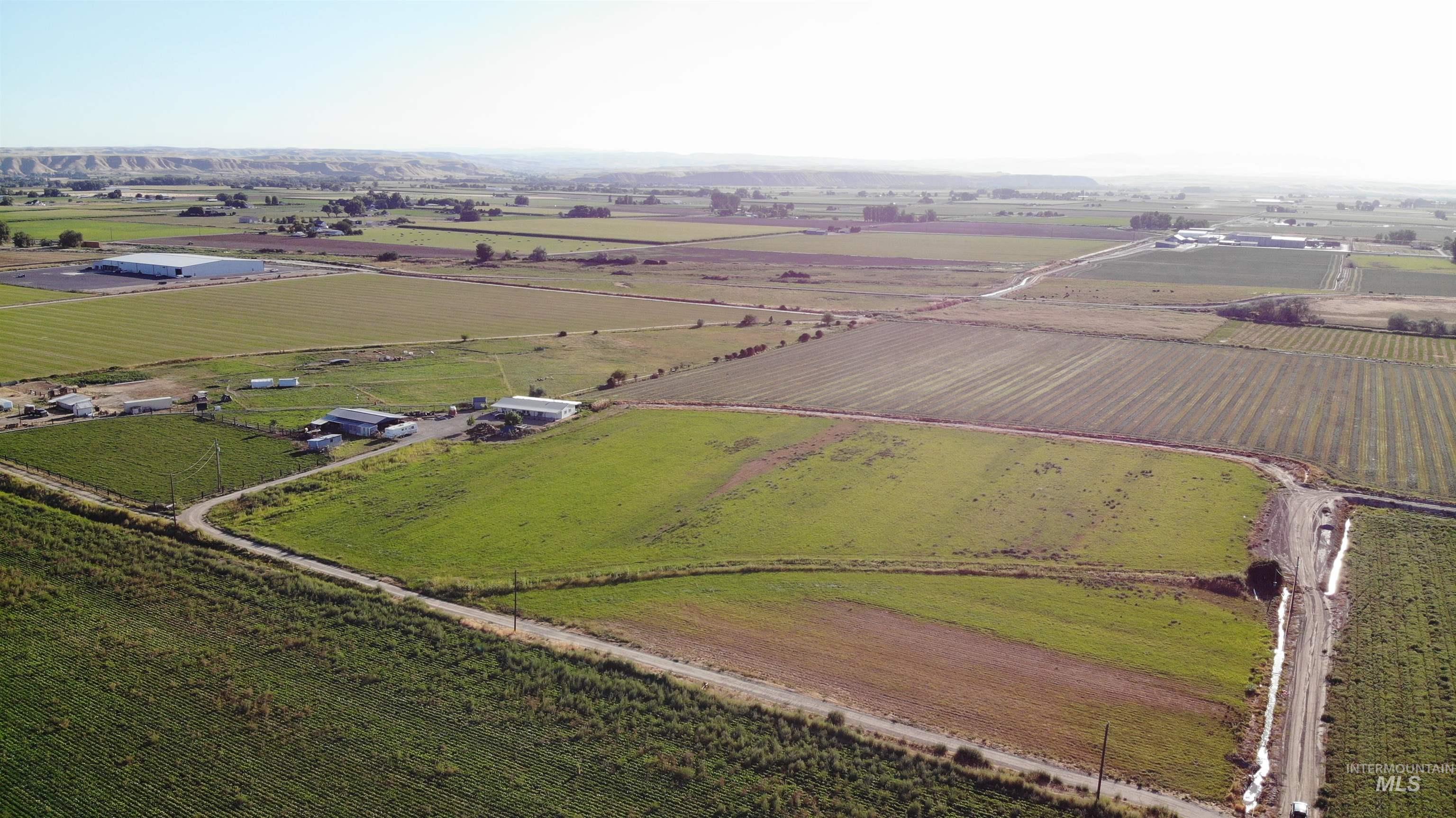 Aerial overview of property's location with rural landscape and large plots for crops