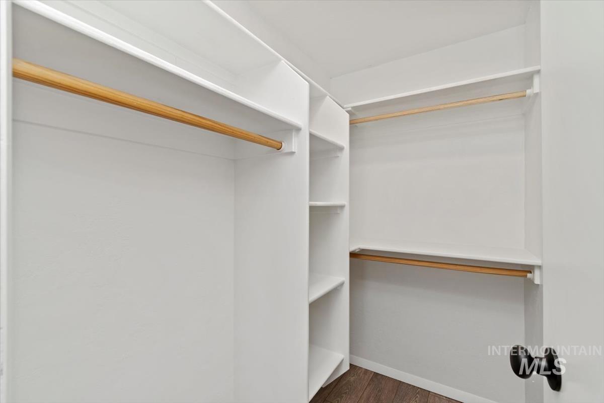 Spacious closet featuring dark wood finished floors