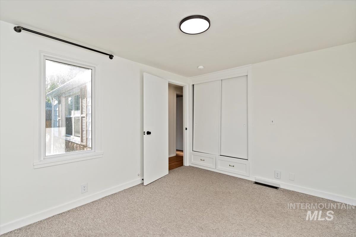 Unfurnished bedroom with carpet flooring and a closet