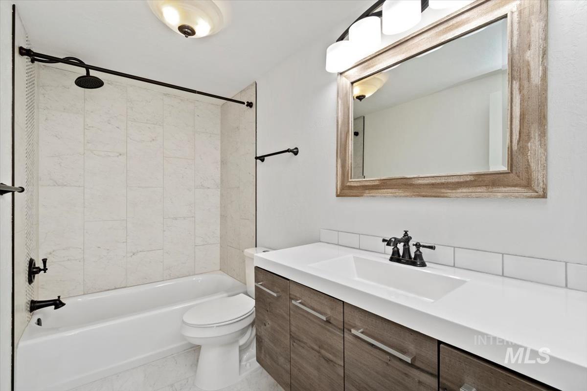 Full bathroom featuring shower / tub combination and vanity