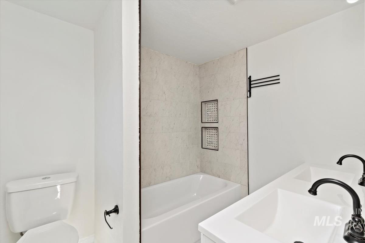 Full bath with bathtub / shower combination and double vanity