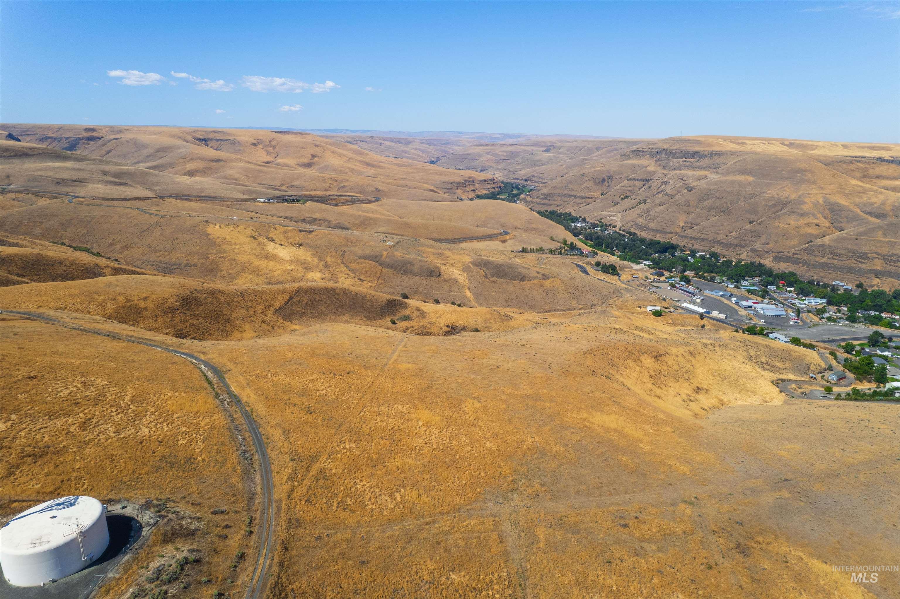 Aerial overview of property's location with a mountain backdrop and rural landscape