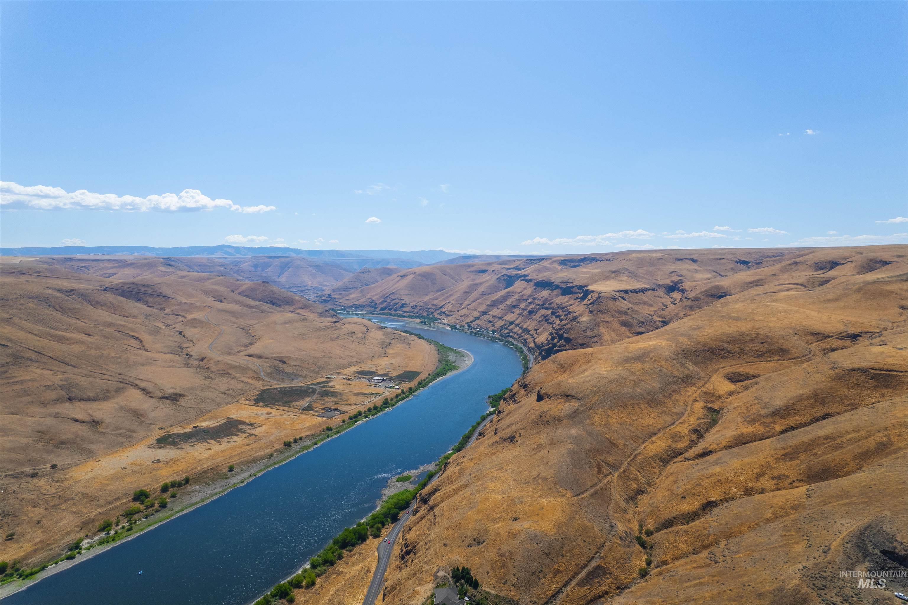 Aerial view of property and surrounding area featuring a water and mountain view