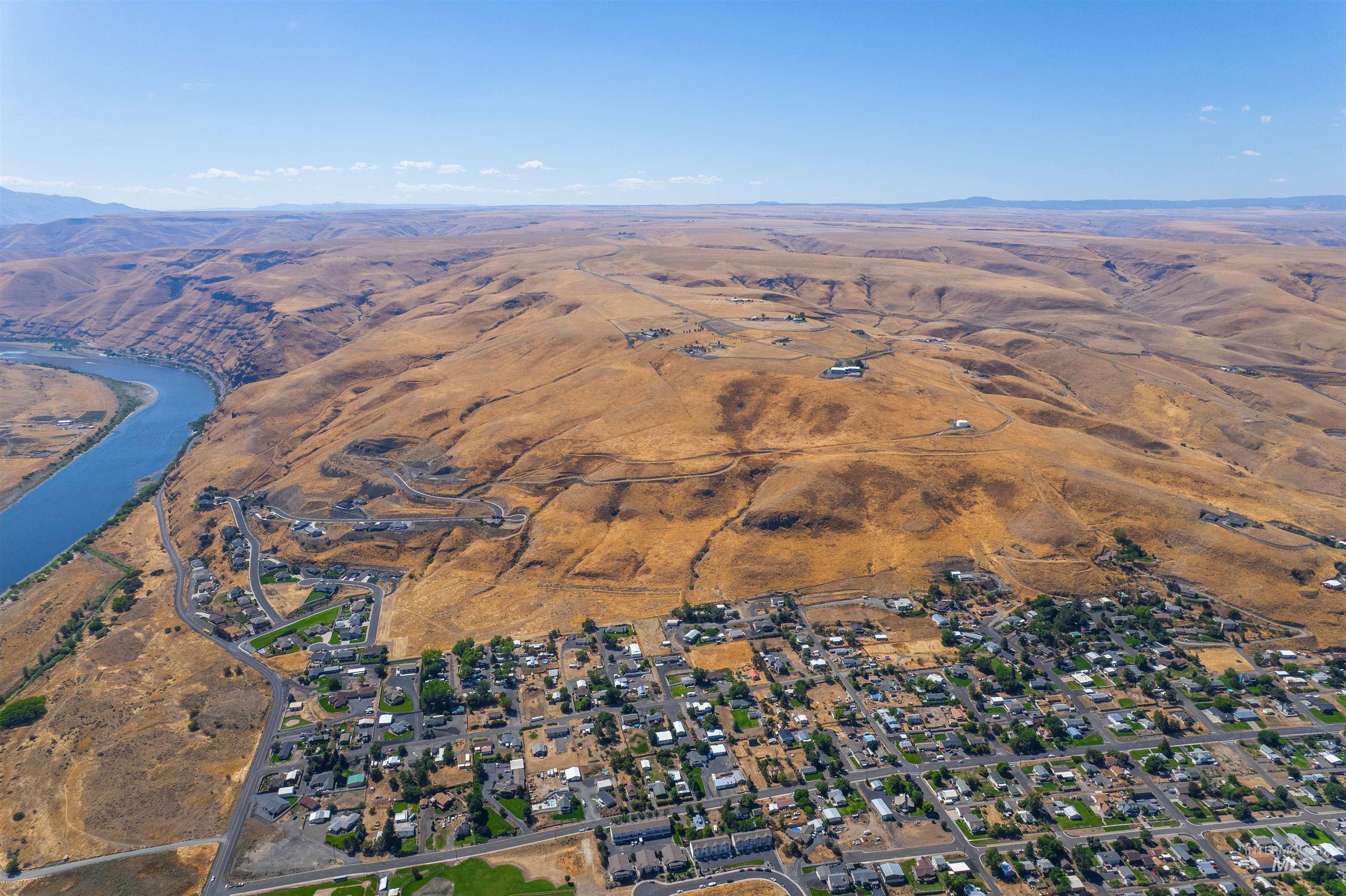 Aerial view of property and surrounding area with a mountainous background
