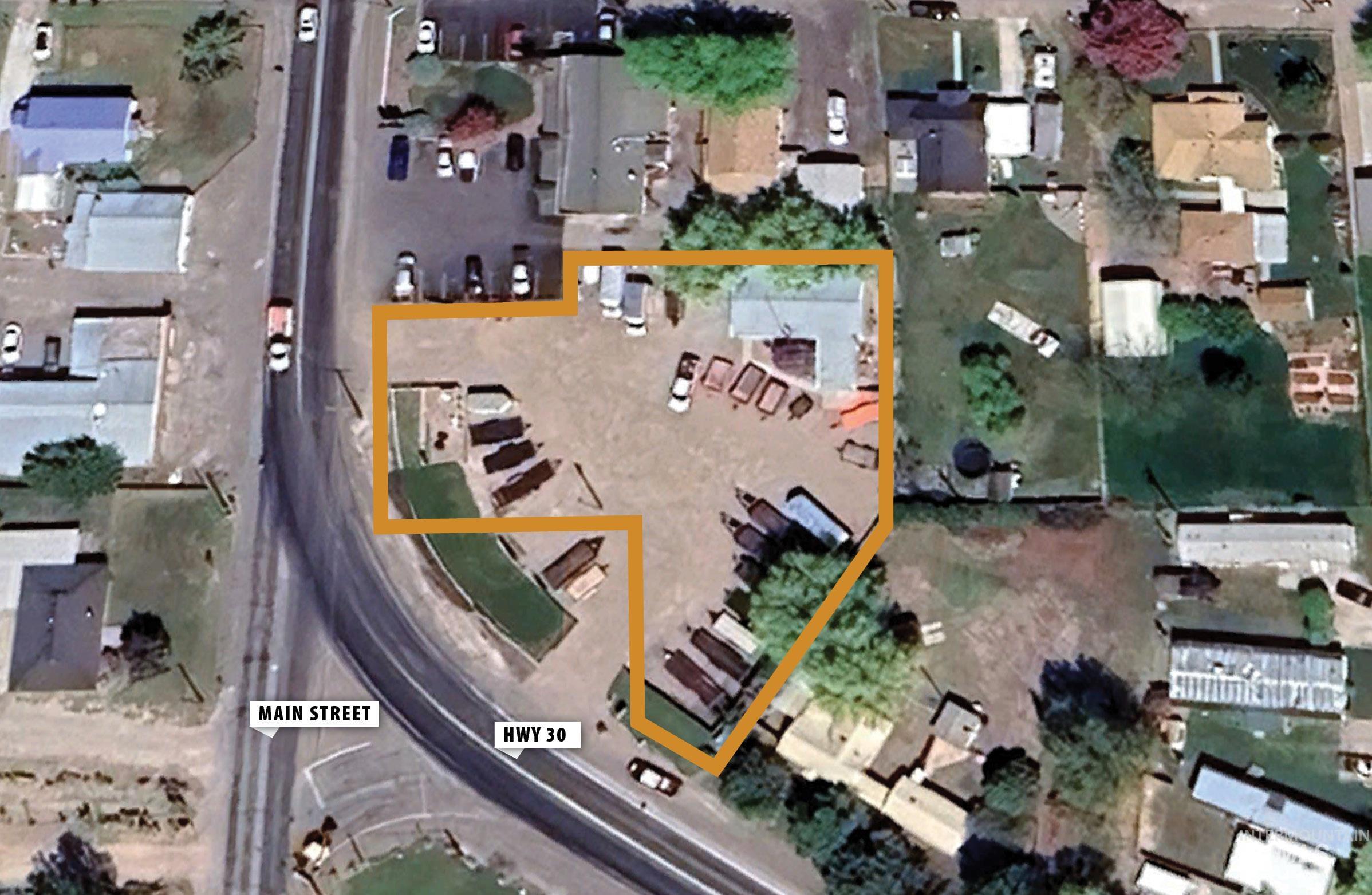Aerial overview of property's location with property boundaries highlighted and nearby suburban area