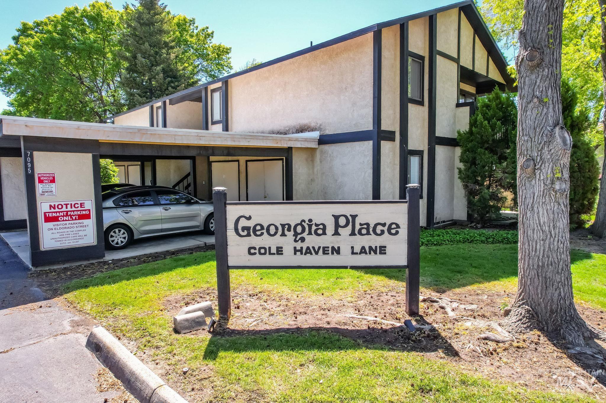 Community / neighborhood sign featuring covered parking