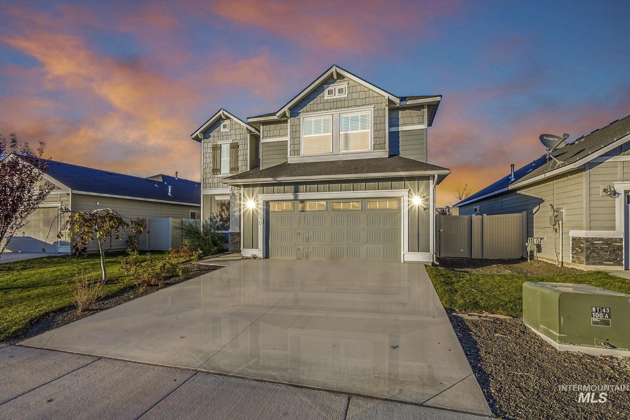 Craftsman house with an attached garage and driveway