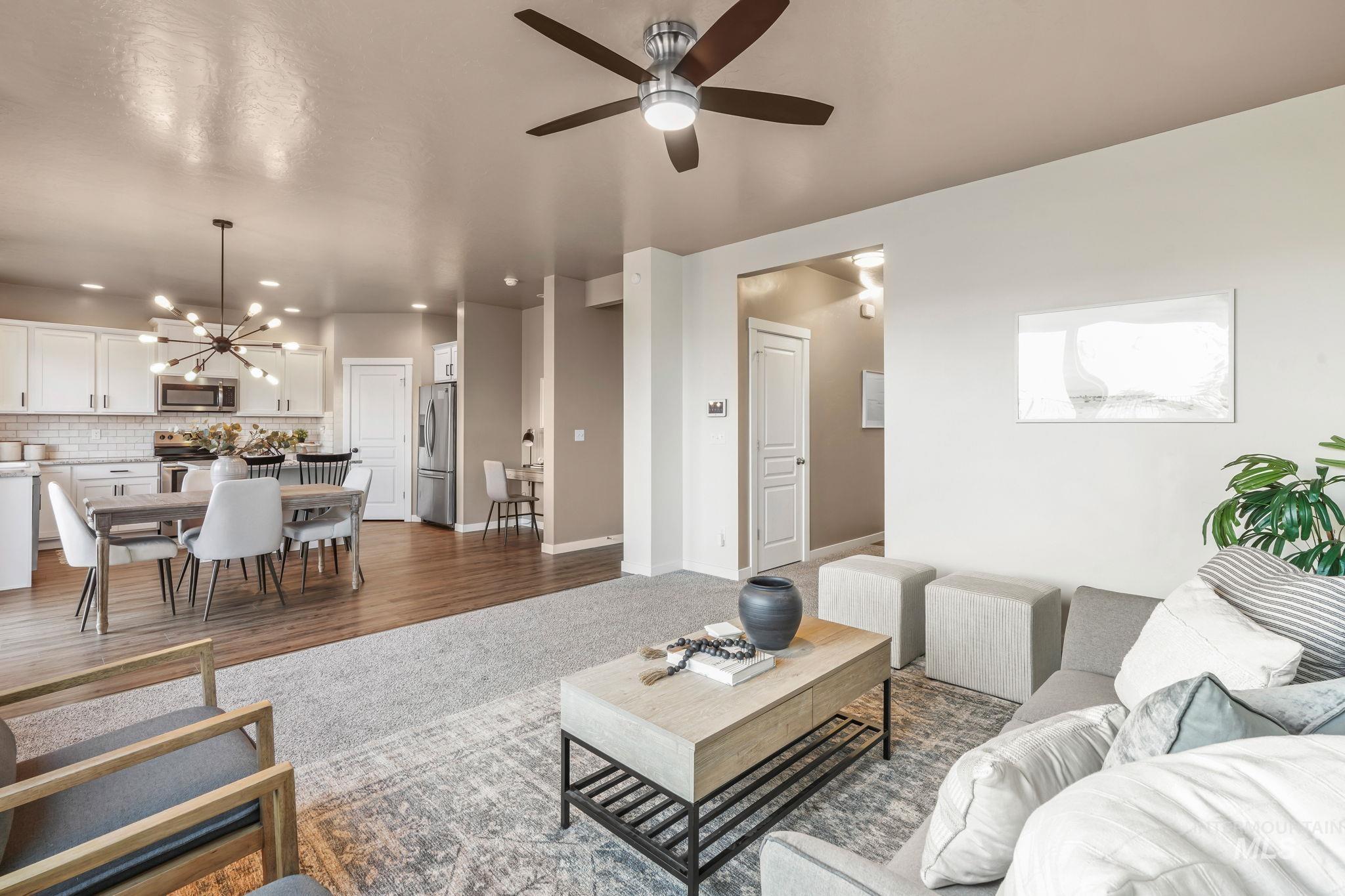 Living area featuring dark wood-style floors, a chandelier, ceiling fan, and recessed lighting