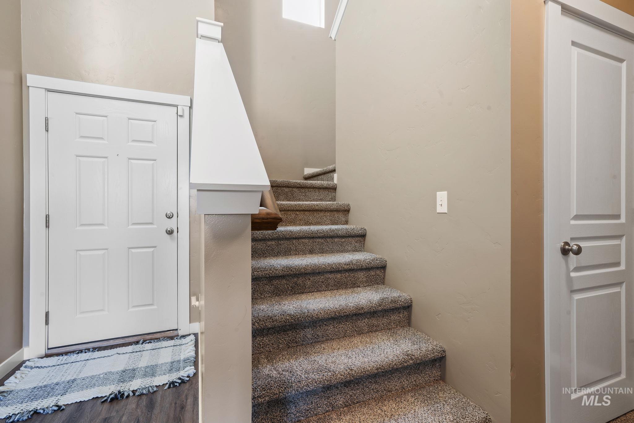 Stairway featuring wood finished floors