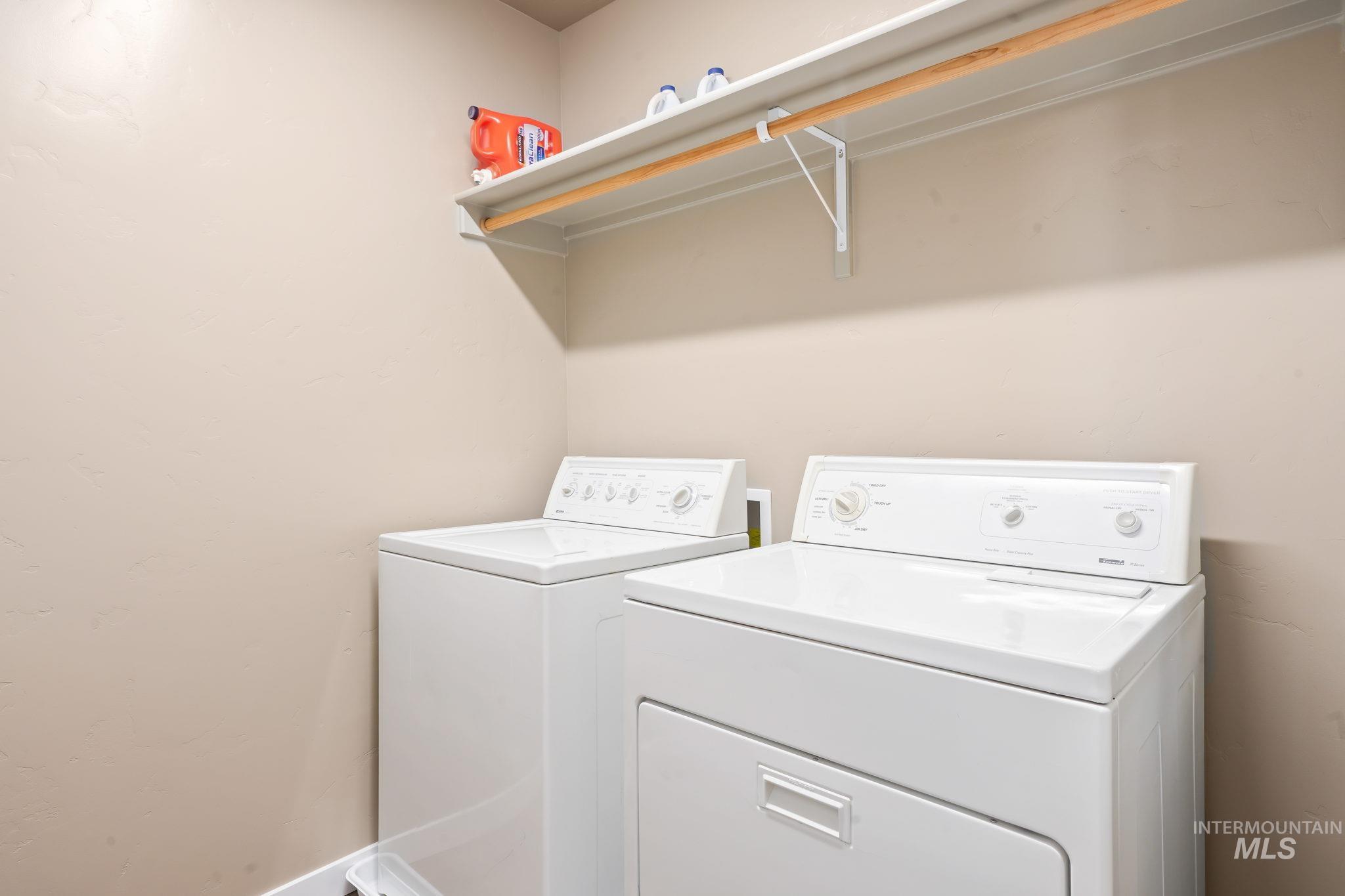 Laundry room with washing machine and dryer and baseboards