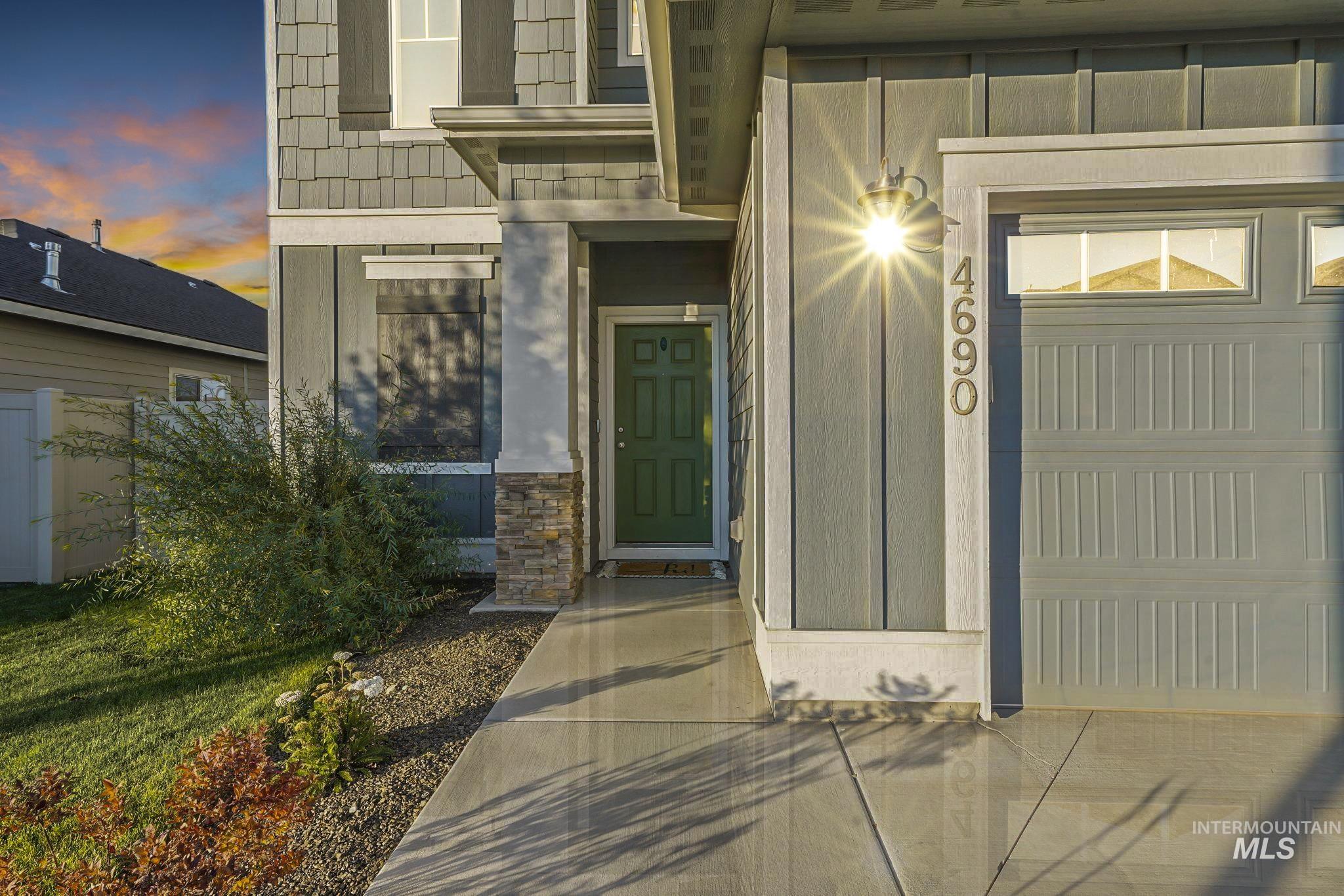 Exterior entry at dusk with stone siding