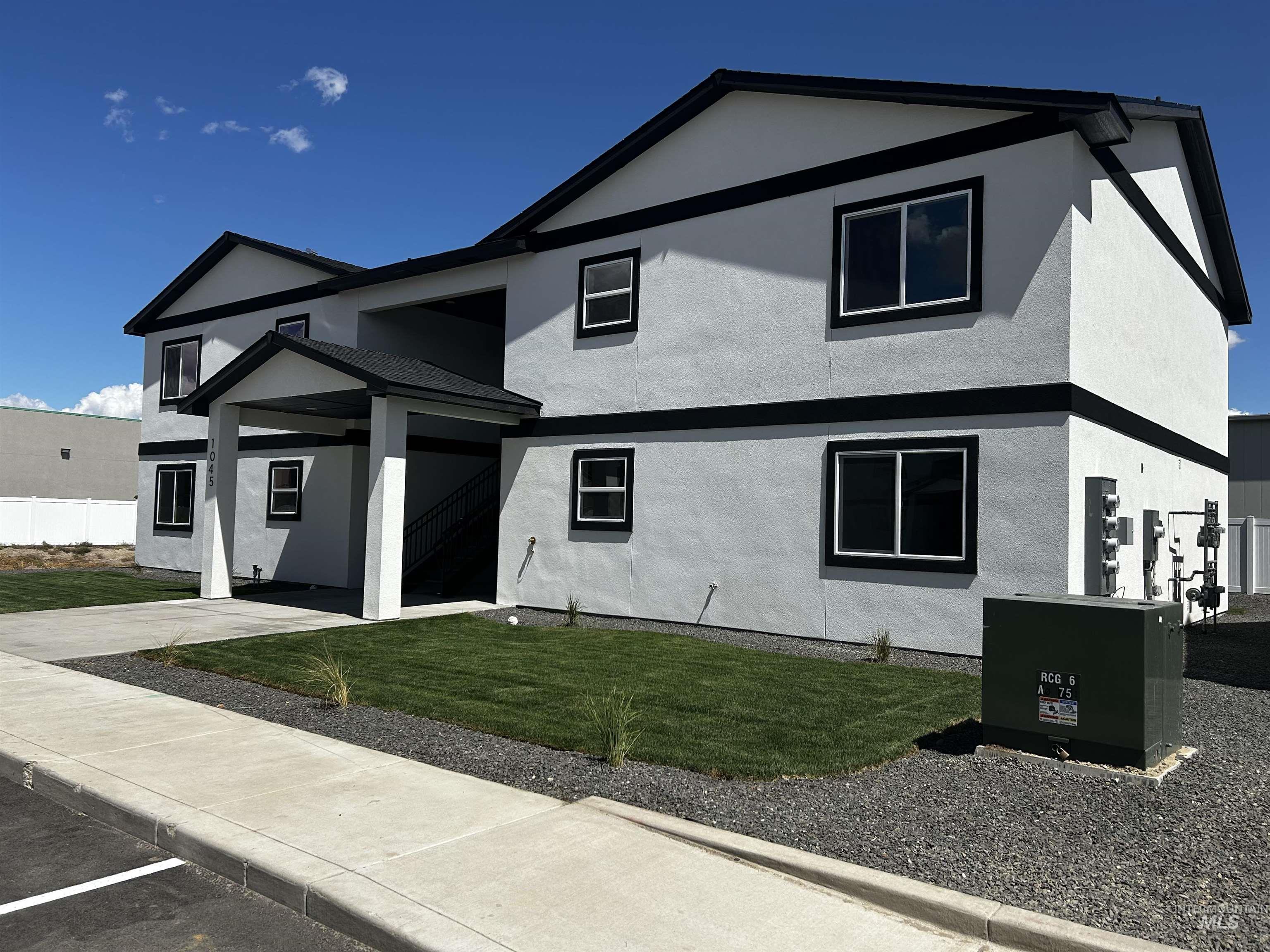 View of front of home with stucco siding and a front yard