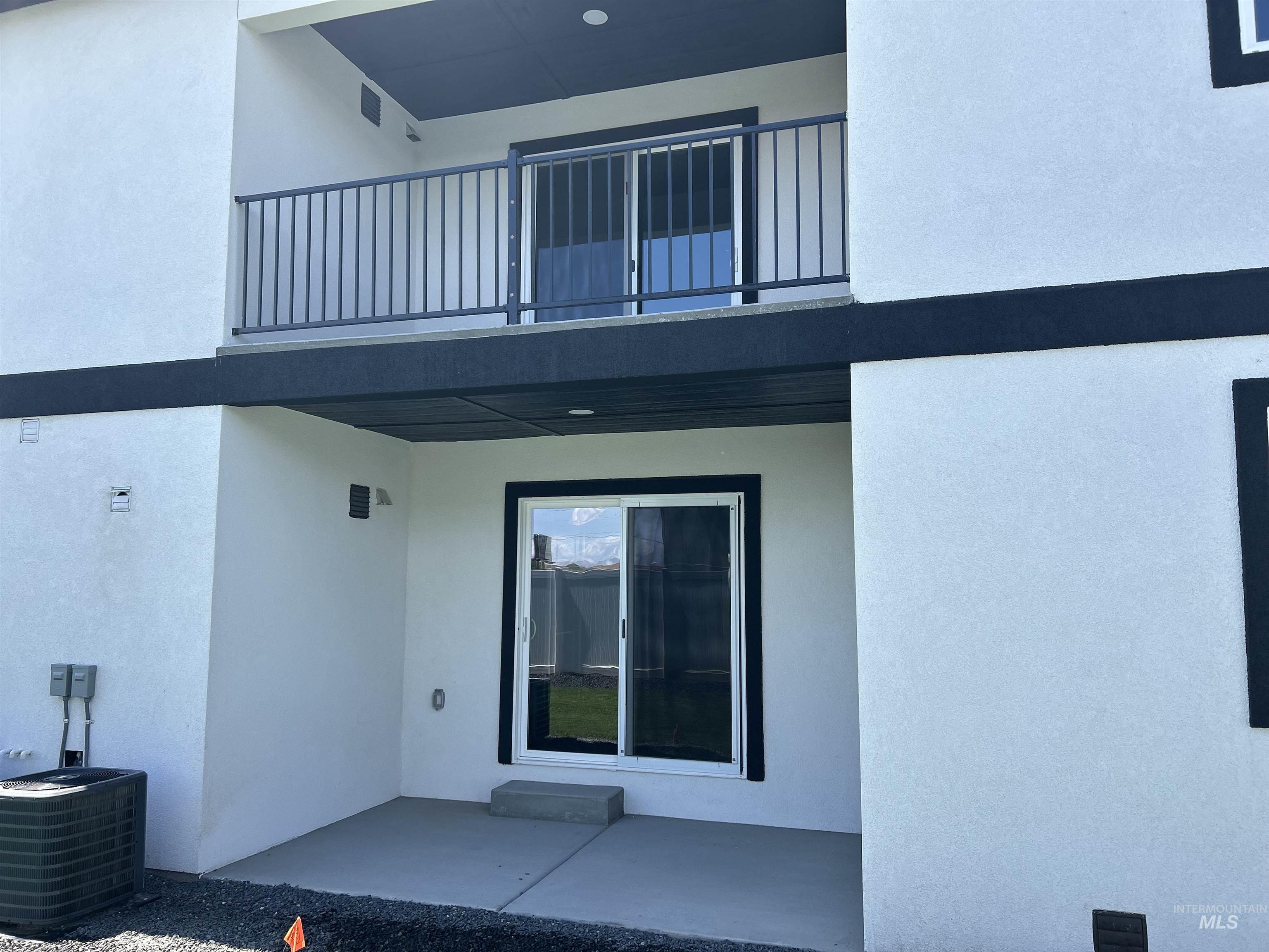 Property entrance featuring a patio and stucco siding