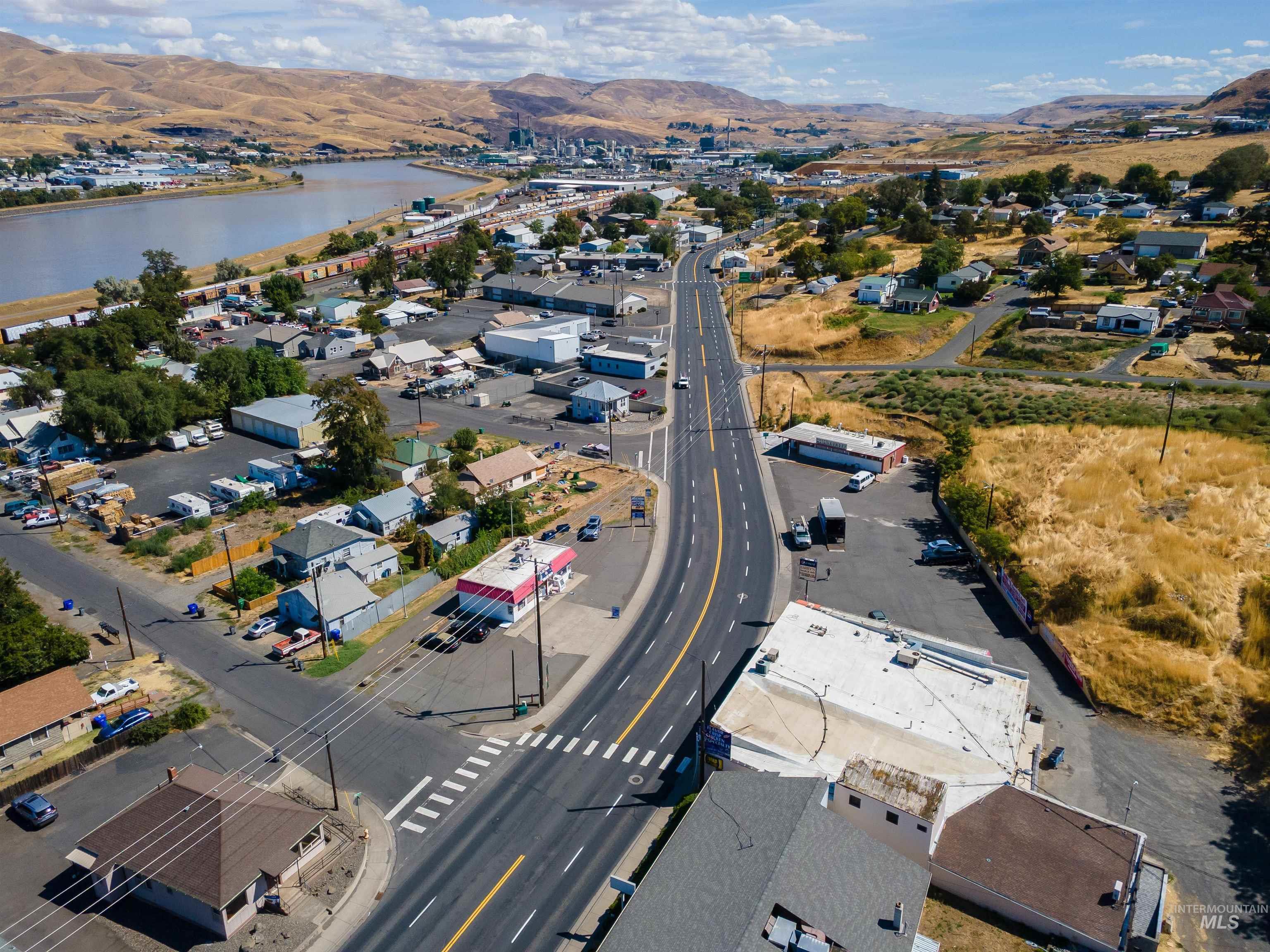 View of property location featuring nearby suburban area and a water and mountain view