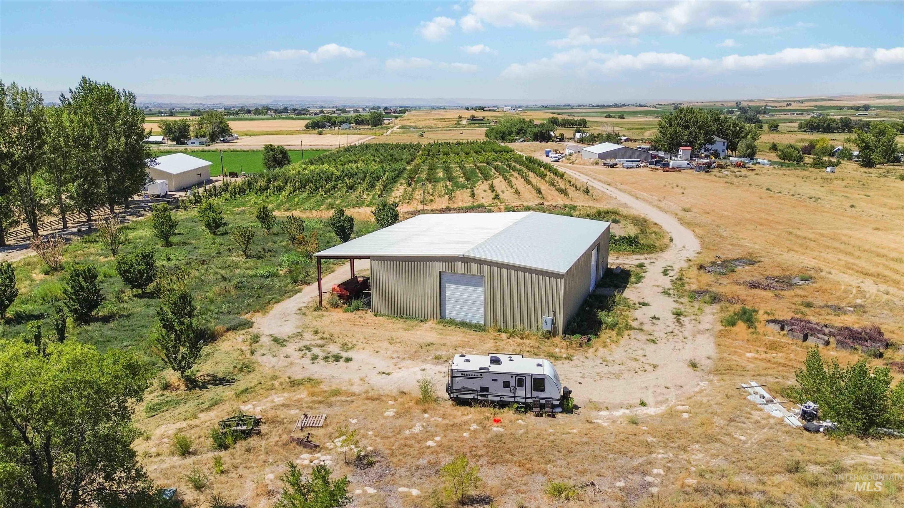 Aerial view of sparsely populated area featuring large plots for crops