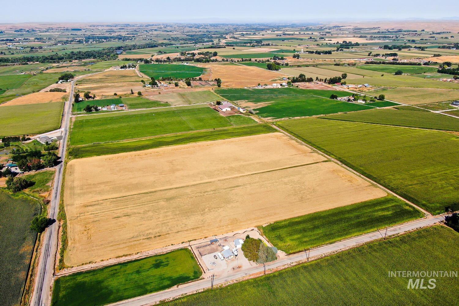 Aerial overview of property's location with rural landscape and farmland