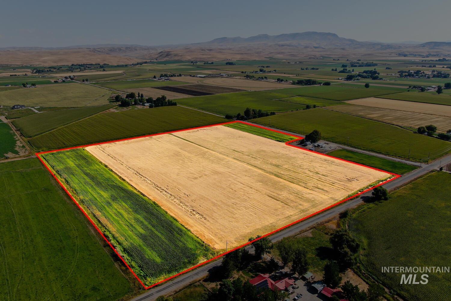 View of rural area featuring mountains, property parcel outlined, and abundant farmland
