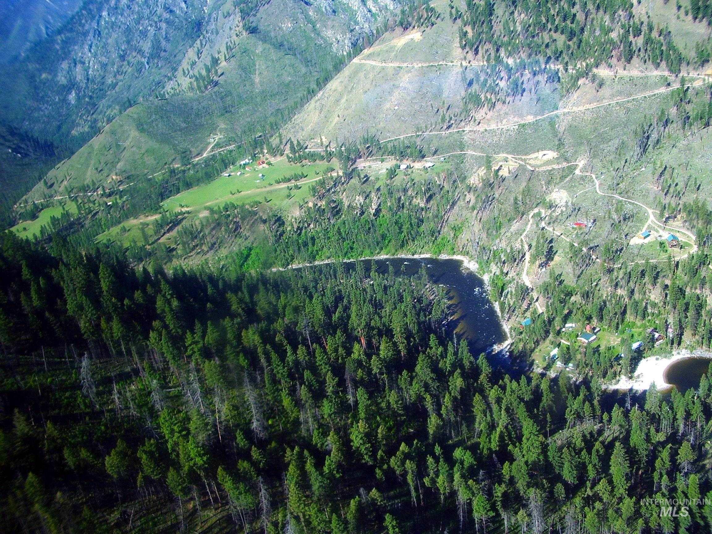 View of property location featuring a forest