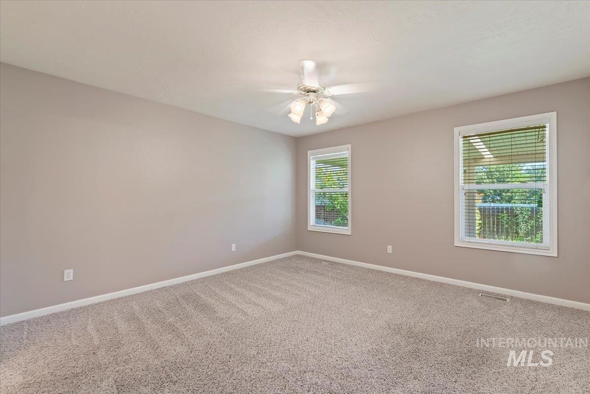 Spare room with carpet floors and ceiling fan