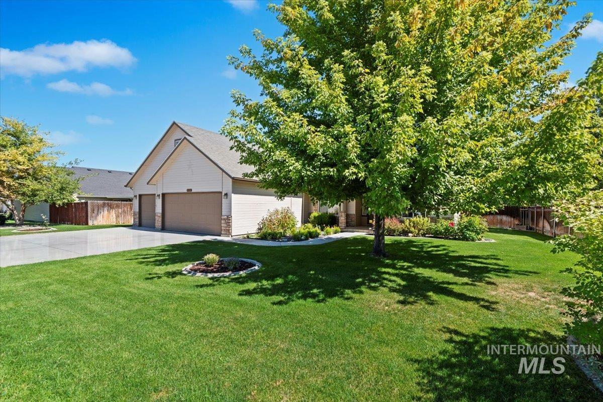 View of front of home featuring driveway, an attached garage, and roof with shingles