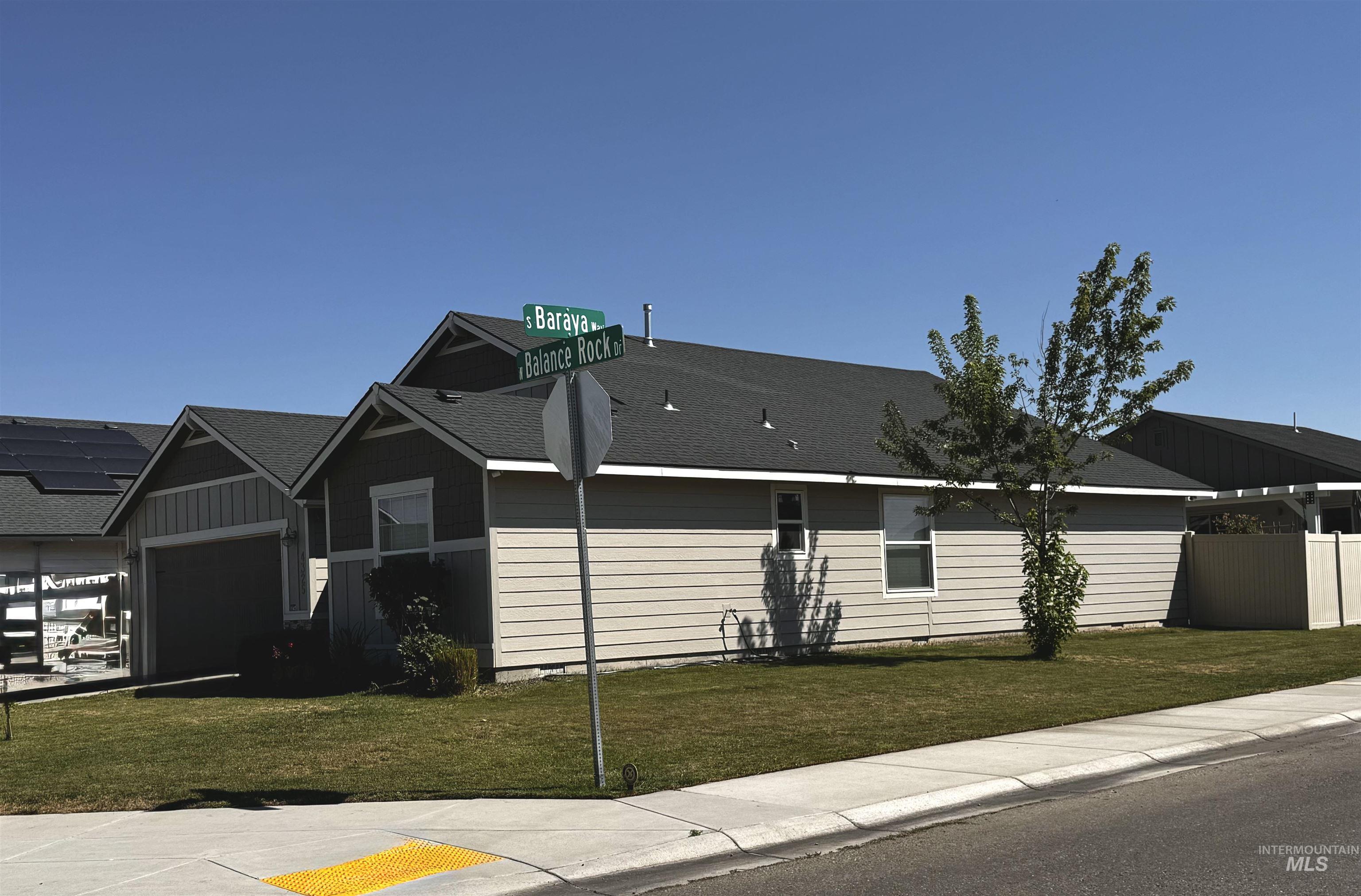 Single story home with roof with shingles and an attached garage