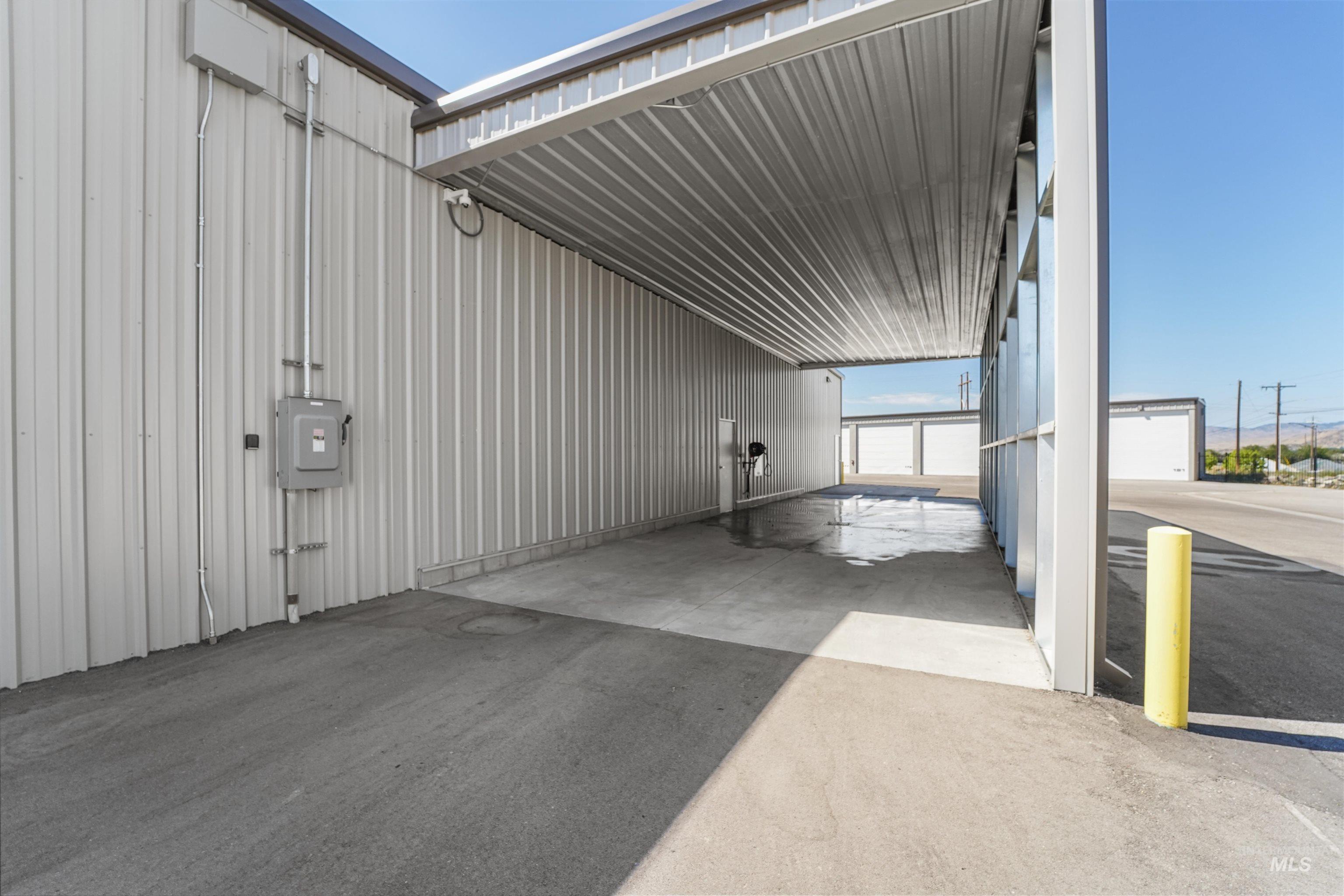 View of vehicle parking featuring concrete driveway and an attached carport