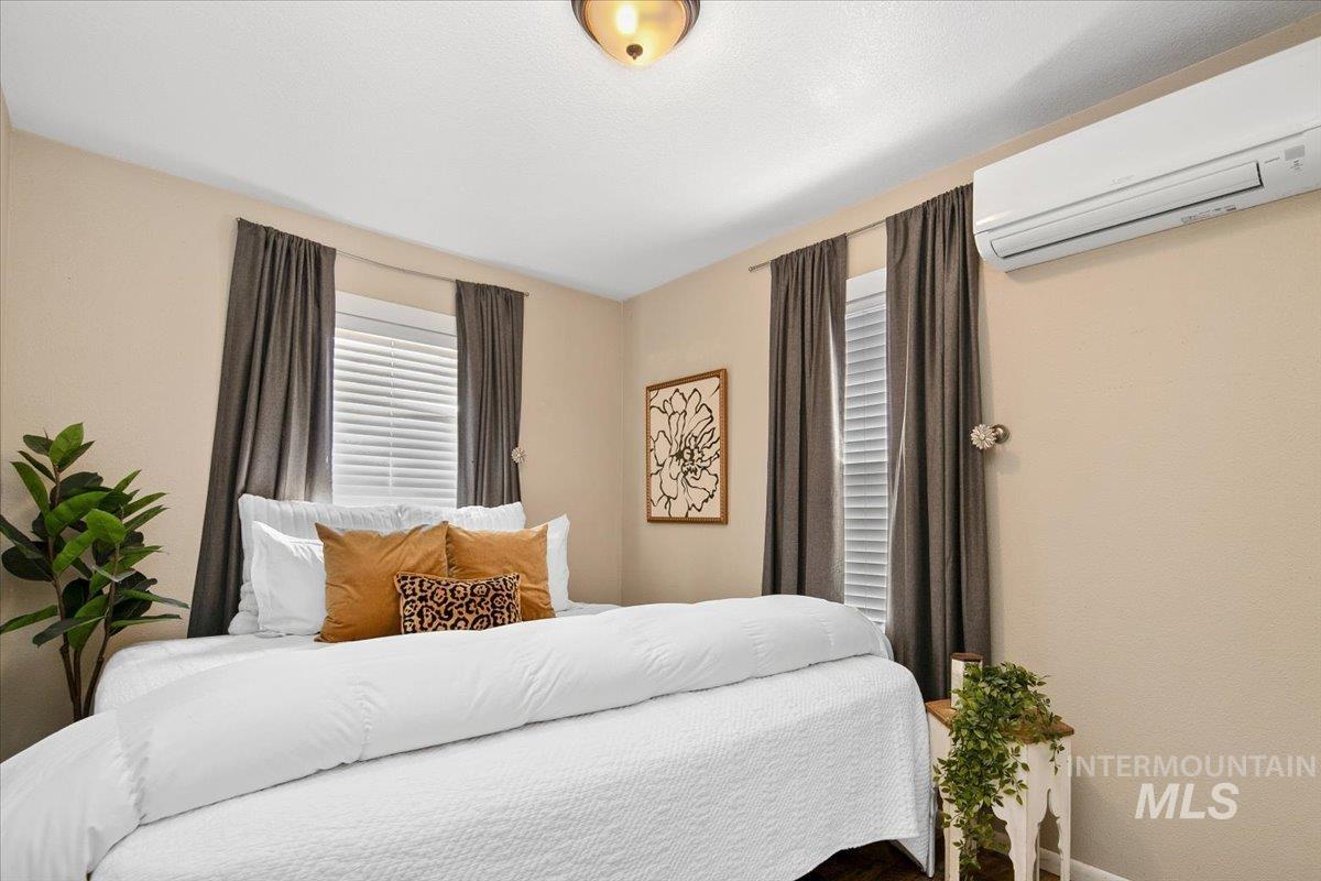 Bedroom with a wall mounted air conditioner