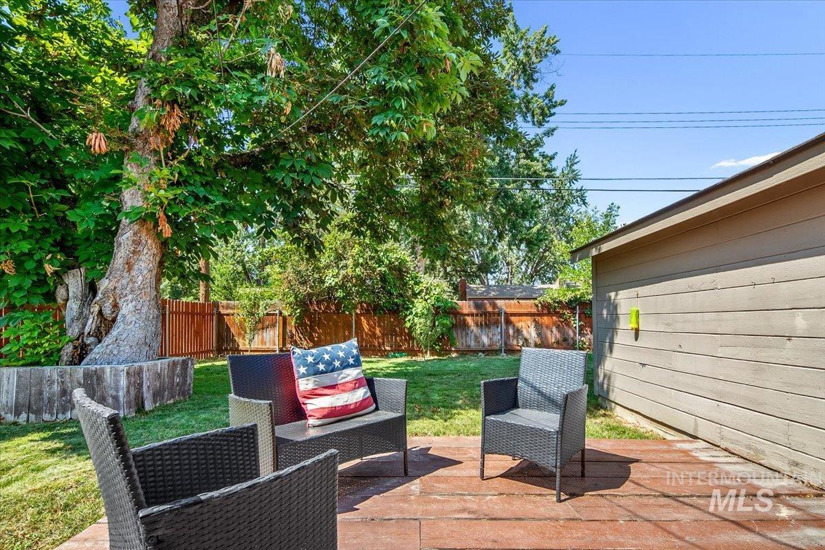 Fenced backyard with a patio