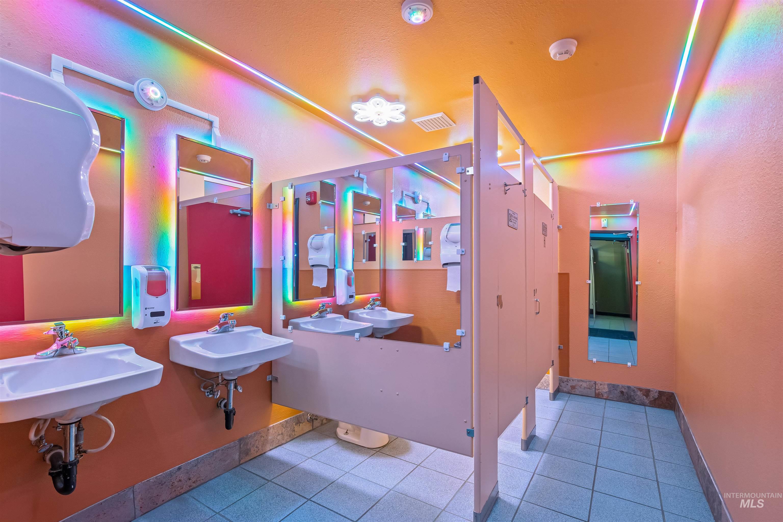 Bathroom featuring light tile patterned flooring and baseboards