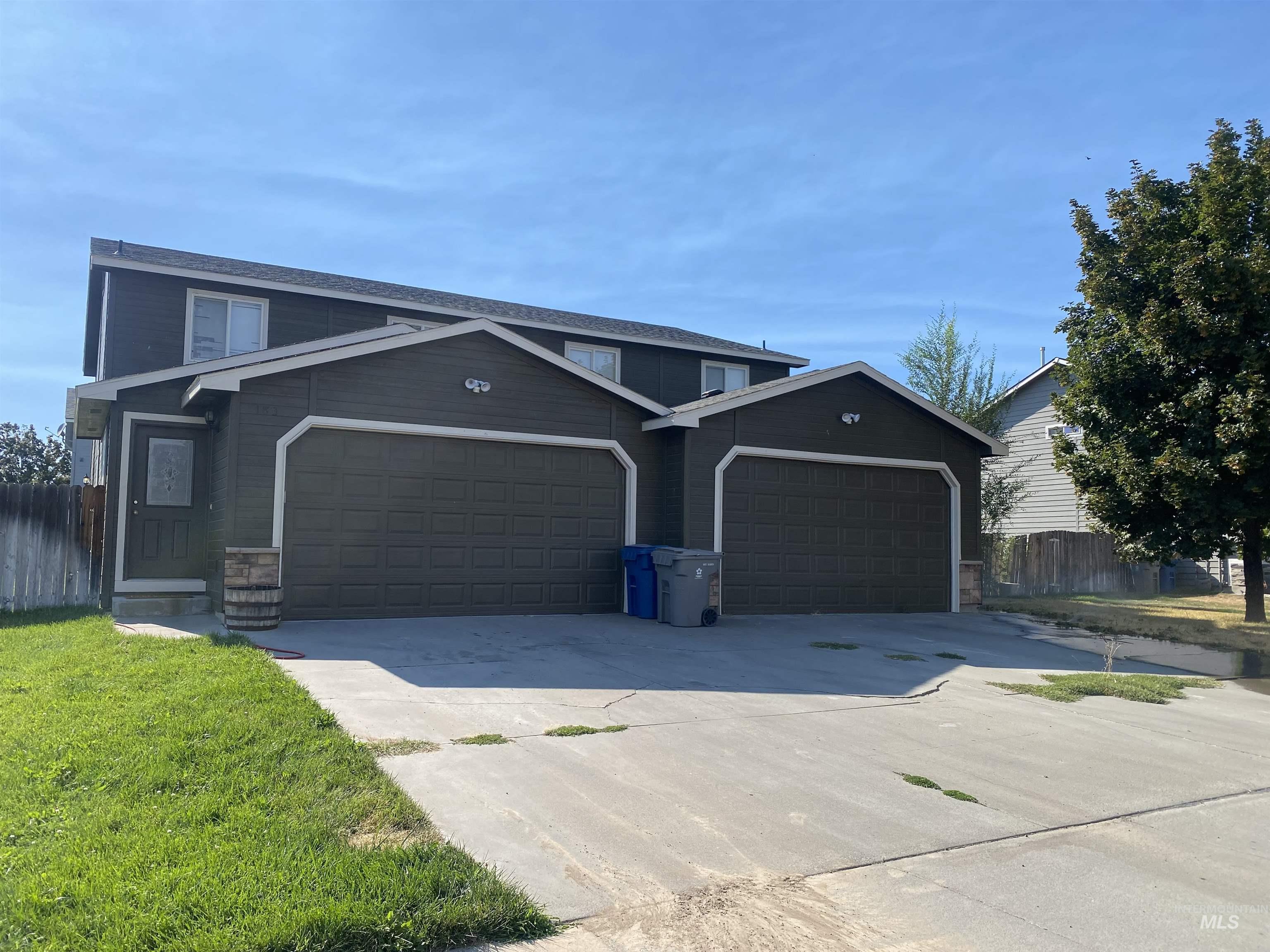 View of front of house with driveway and a garage