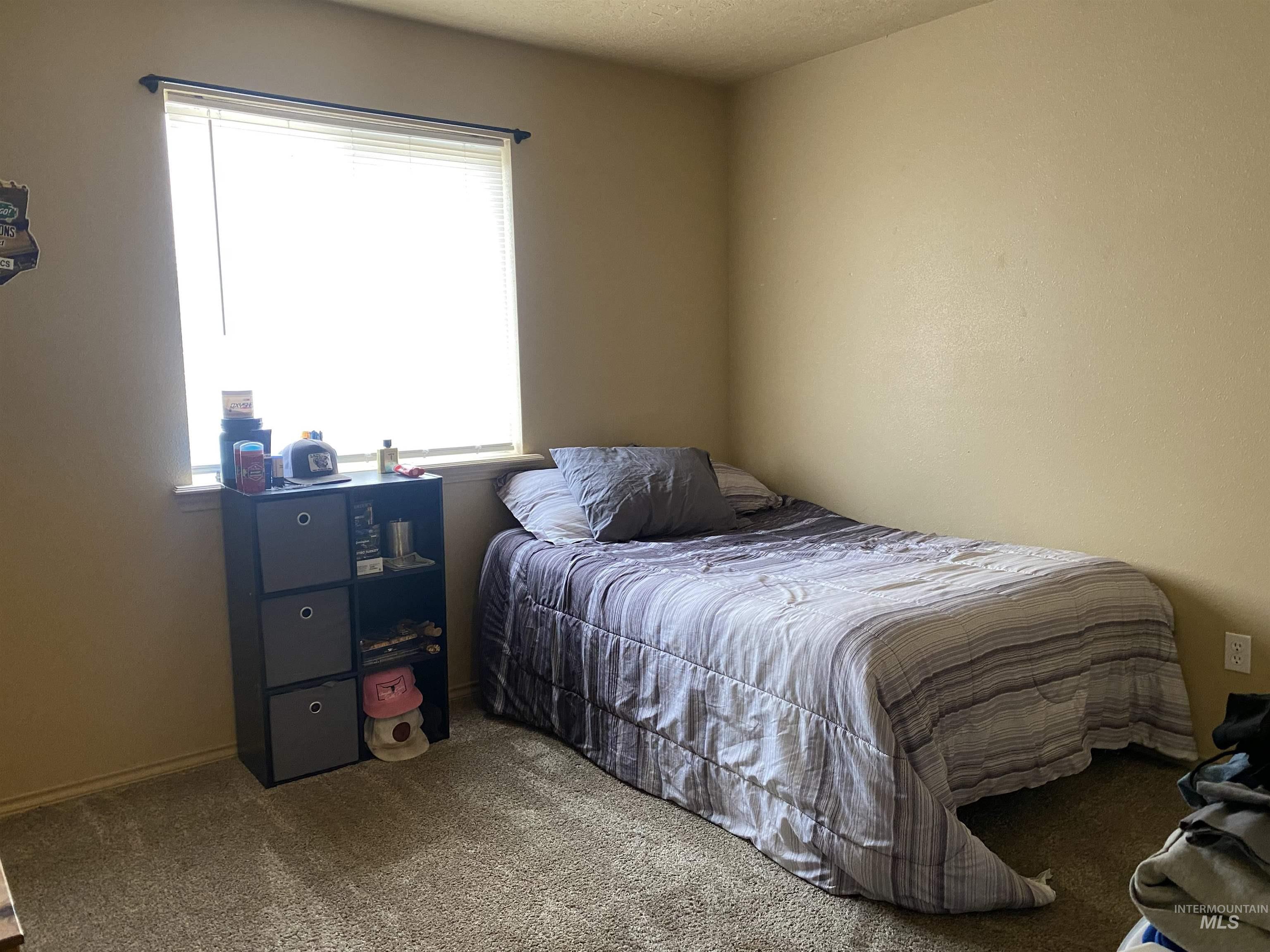Bedroom featuring carpet flooring and a textured ceiling