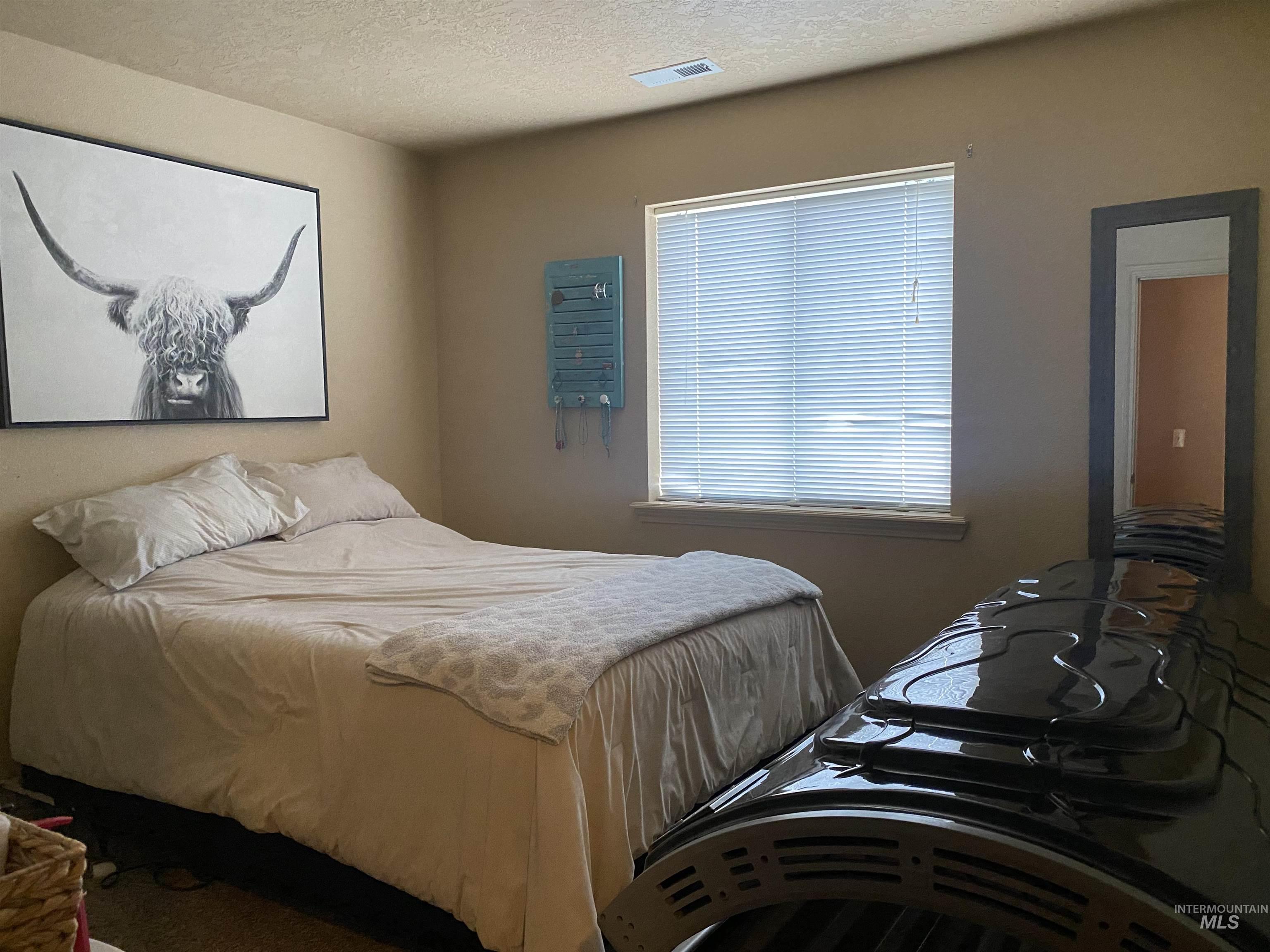Bedroom featuring a textured ceiling
