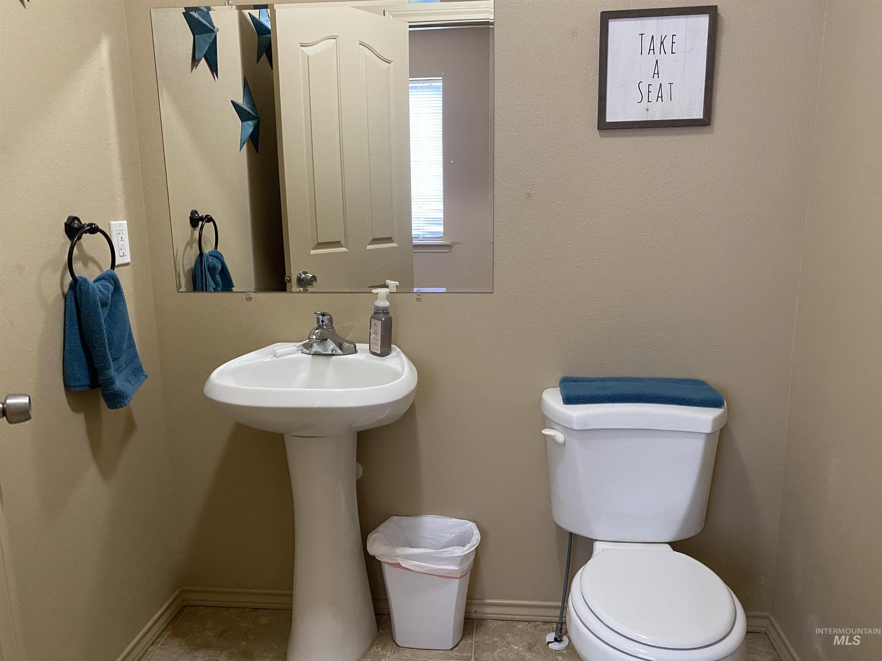 Bathroom featuring toilet and baseboards