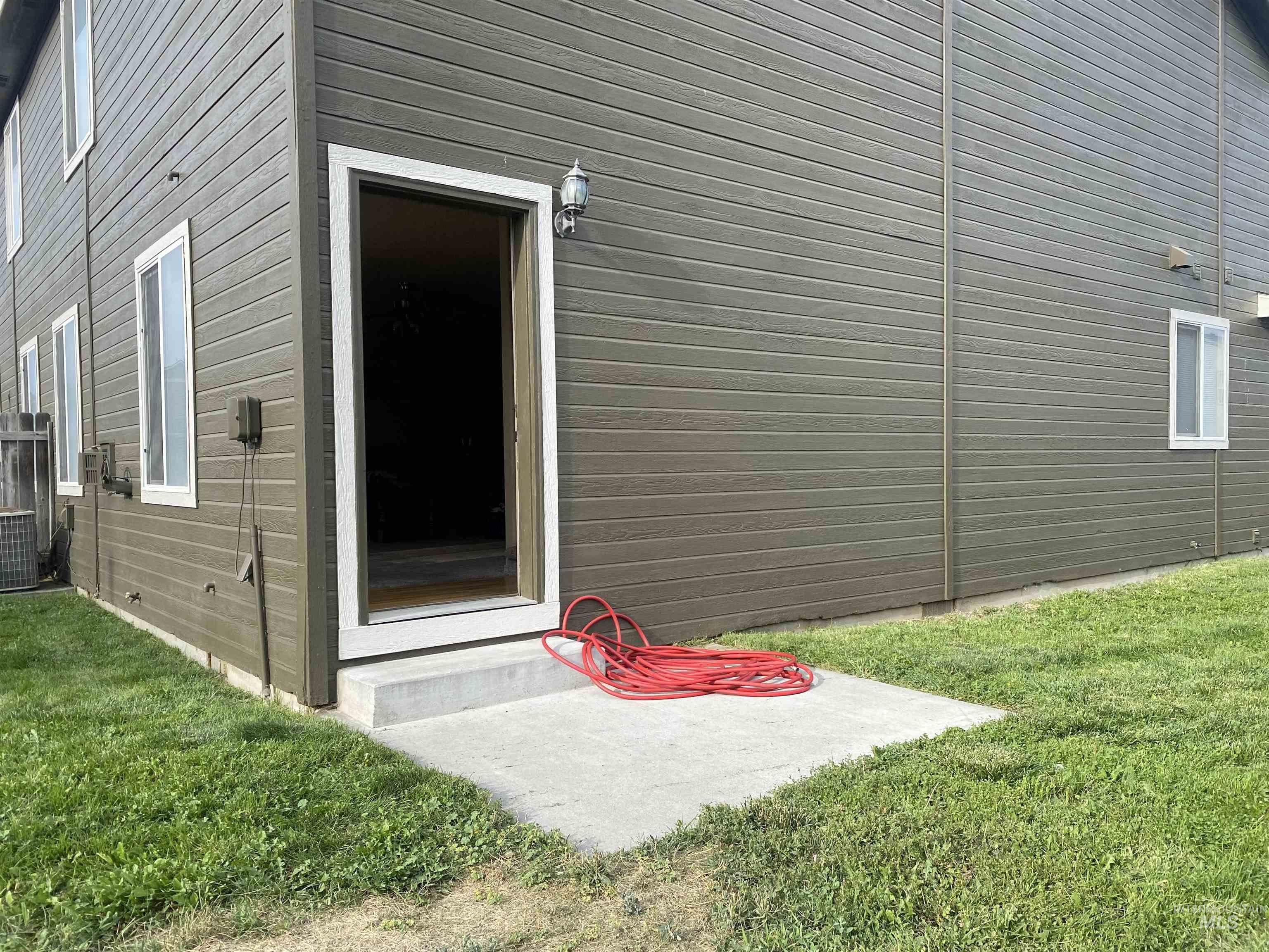 View of side of home featuring a lawn
