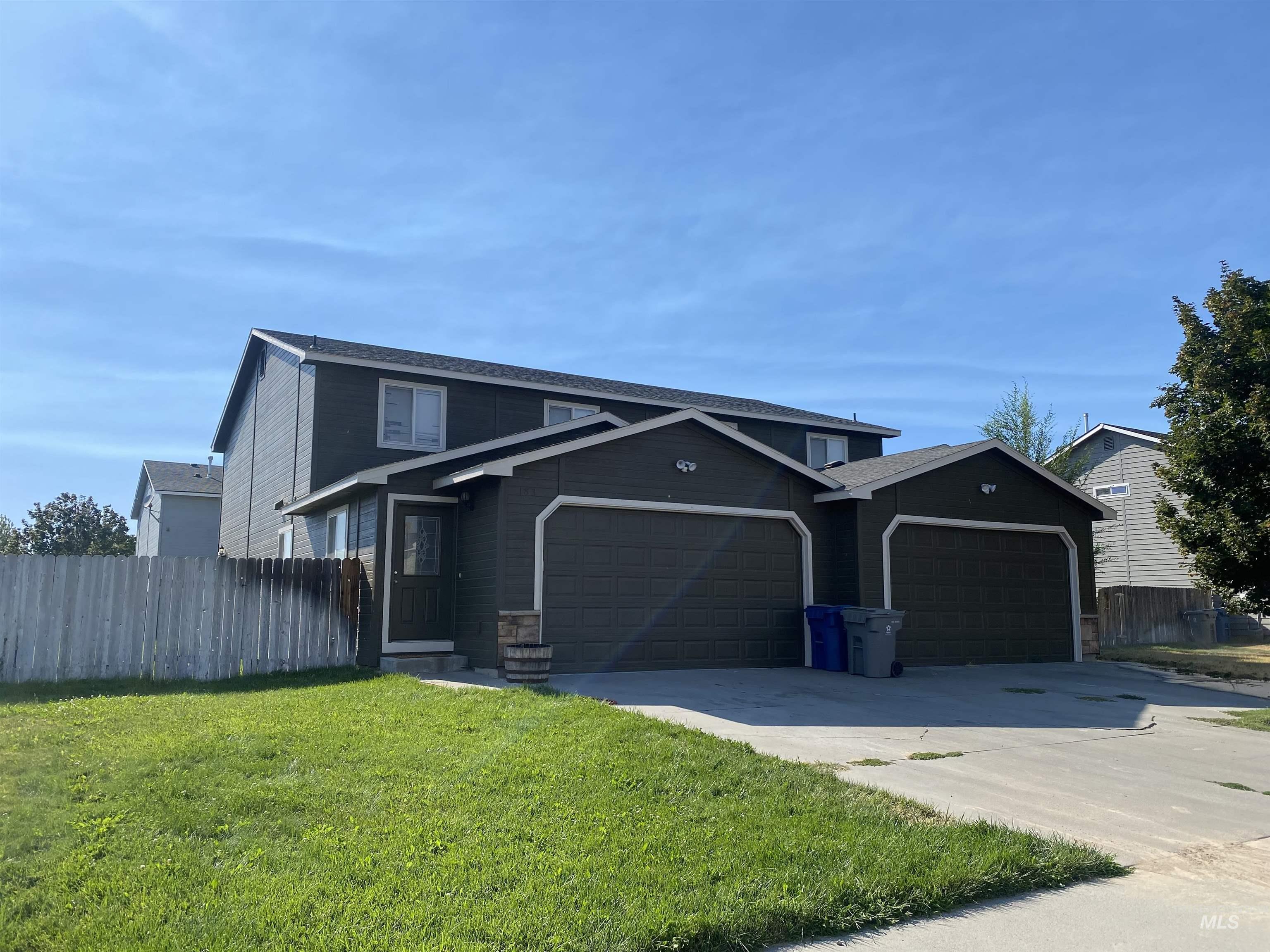 Traditional-style house with an attached garage and concrete driveway