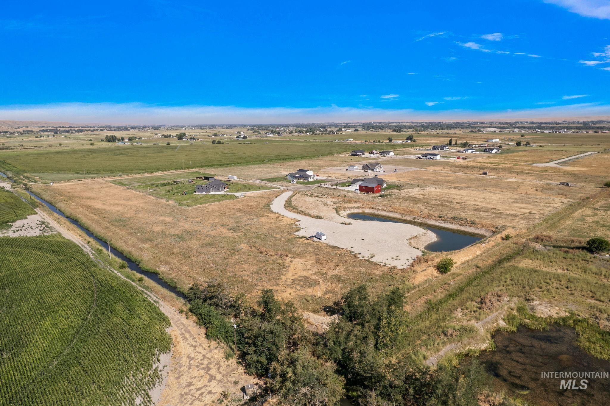 View of property location with rural landscape and a large body of water
