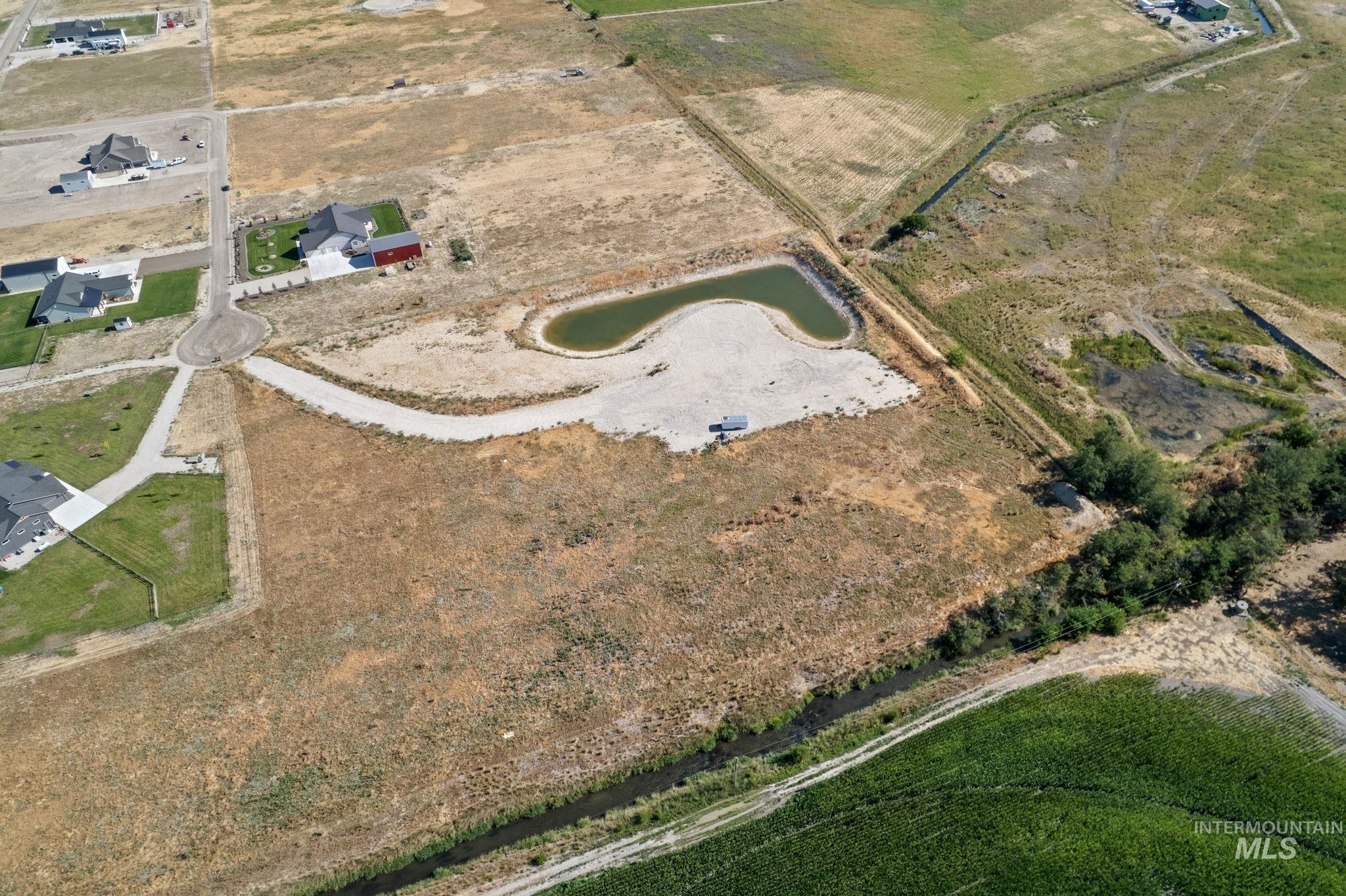 Aerial view of property and surrounding area with rural landscape and a nearby body of water