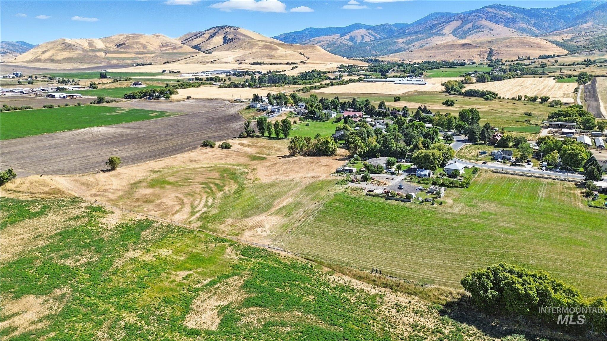 Aerial view of property's location with mountains and rural landscape