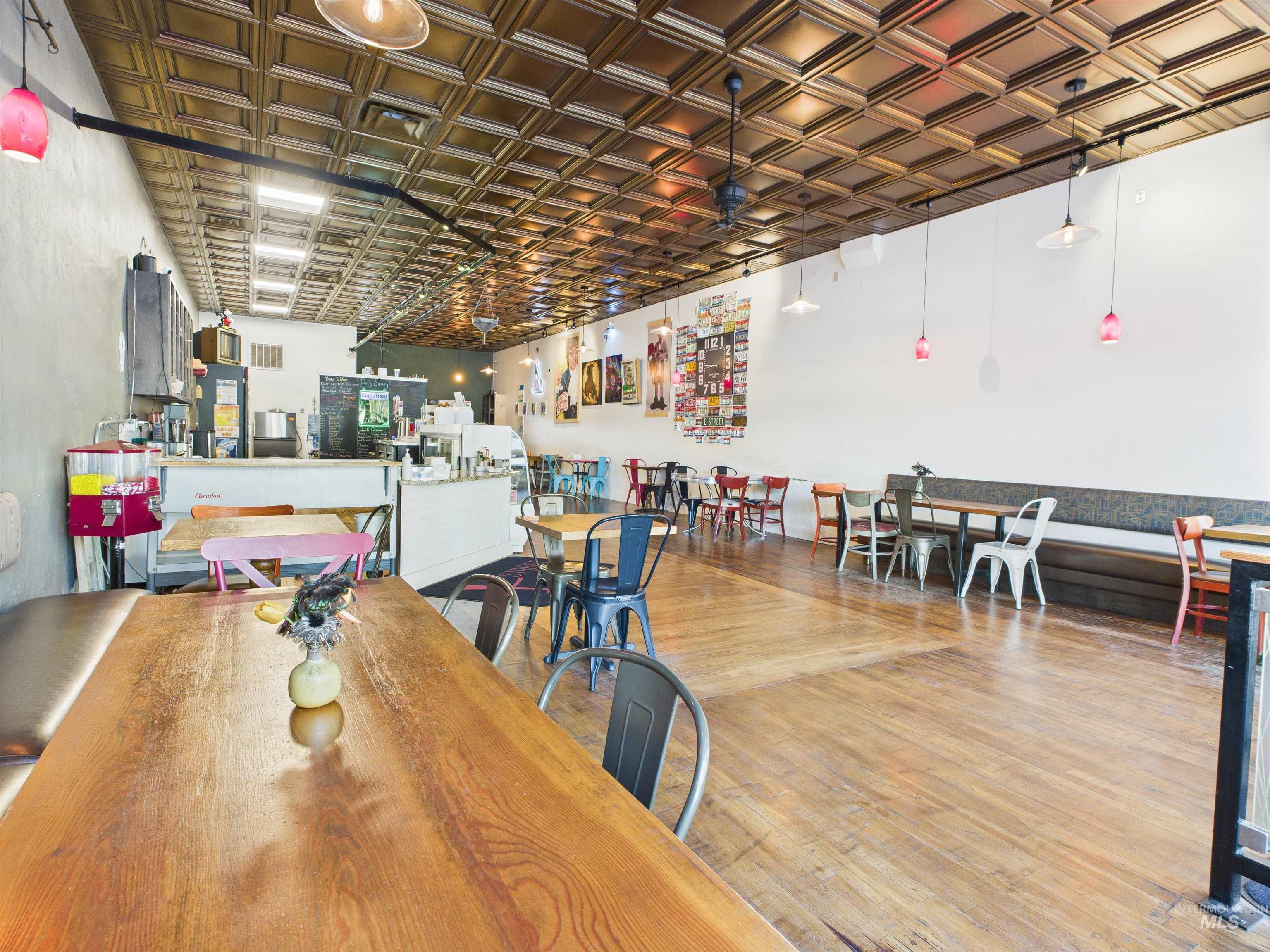 Dining area with light wood-style floors and an ornate ceiling